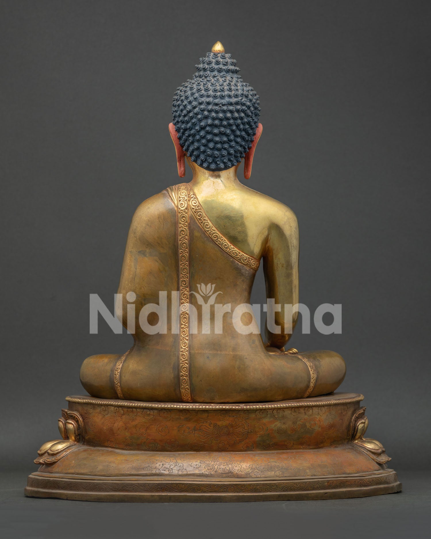 Back view of lost-wax copper Shakyamuni Buddha statue on lotus throne