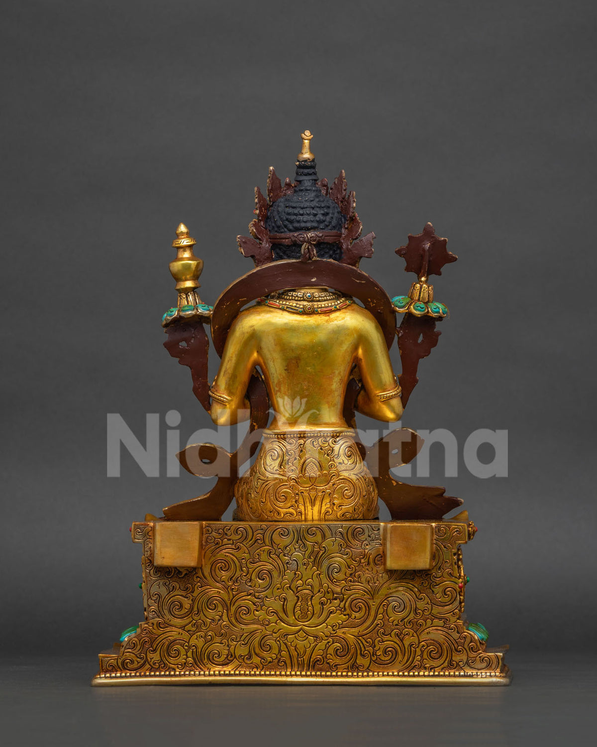 Back view of Maitreya Buddha statue showing gilded throne and aureole