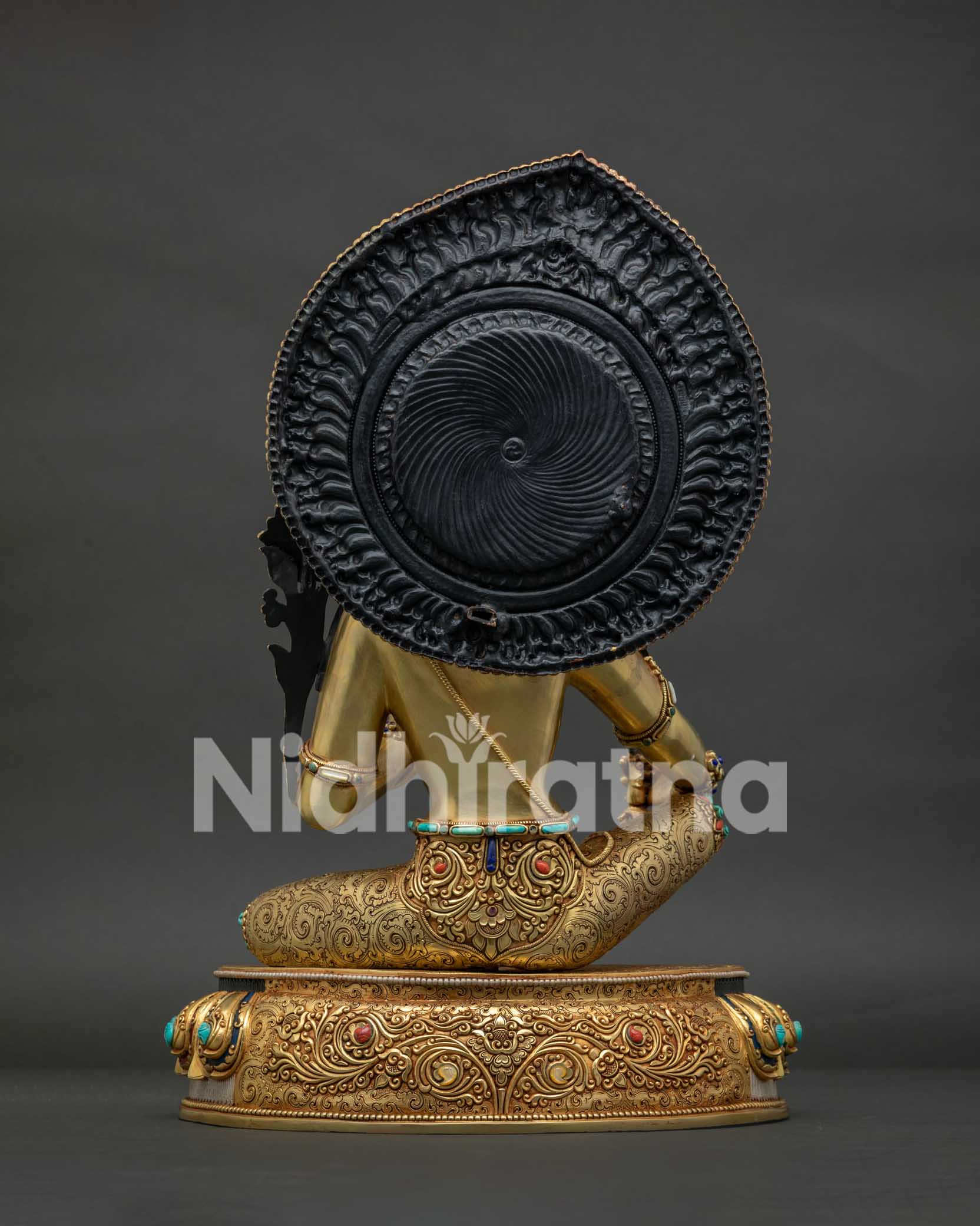Back view of Manjushri Bodhisattva statue — gold filigree halo and copper alloy construction