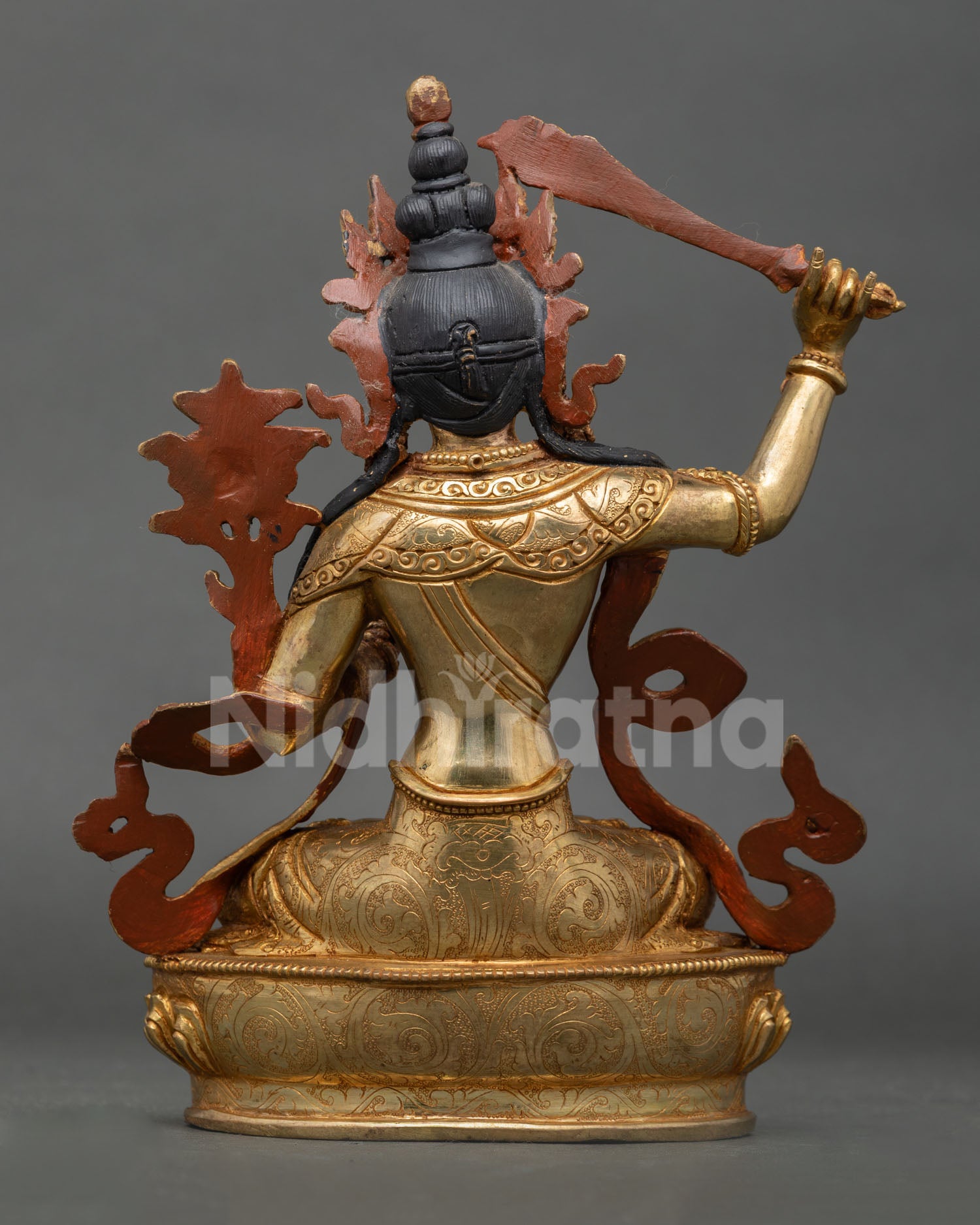 Back view of Manjushri statue, detailed robe engravings and traditional Nepali craftsmanship
