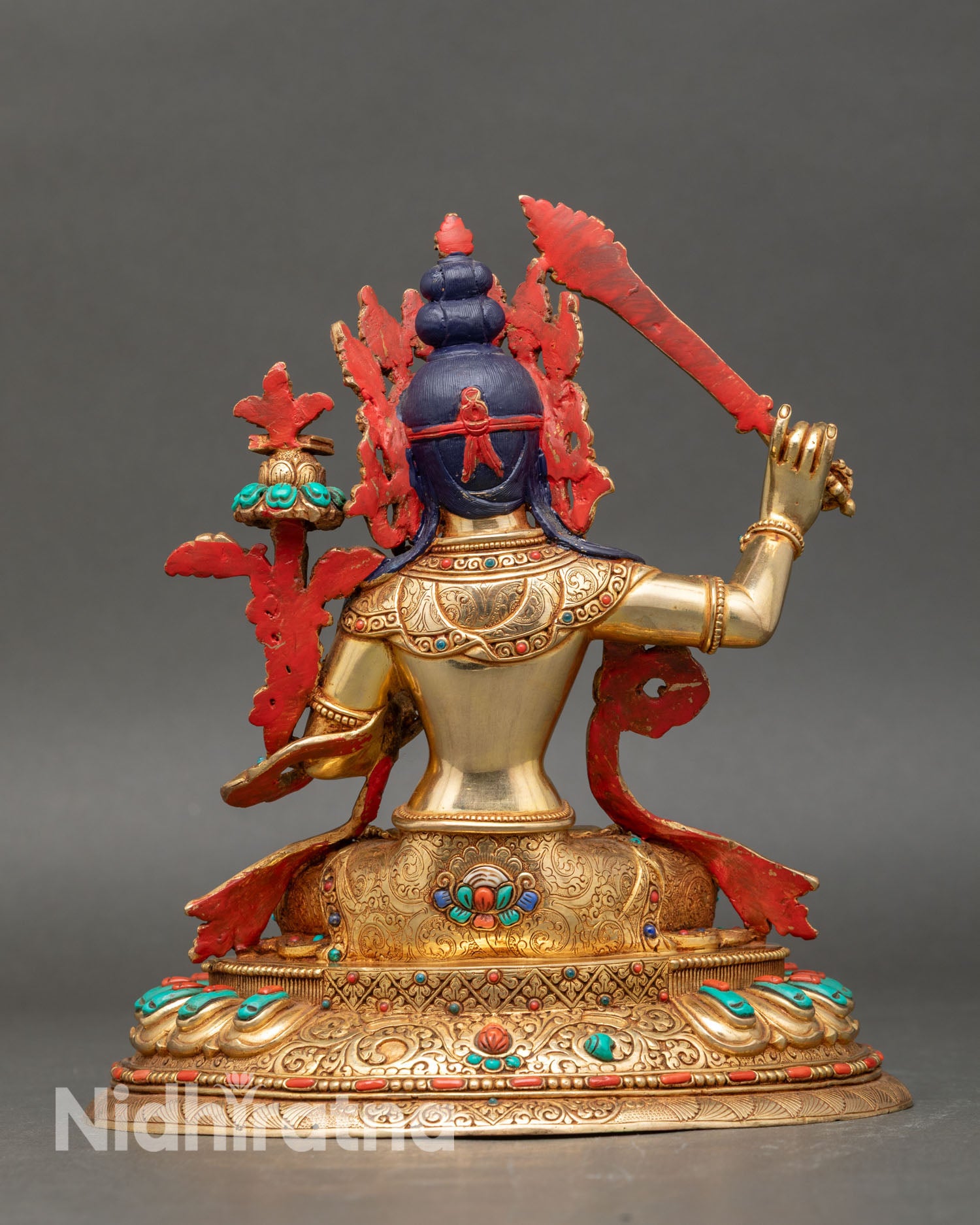 Back view of manjushri statue gold fire-gilded lost-wax casting spiritual energy meditation