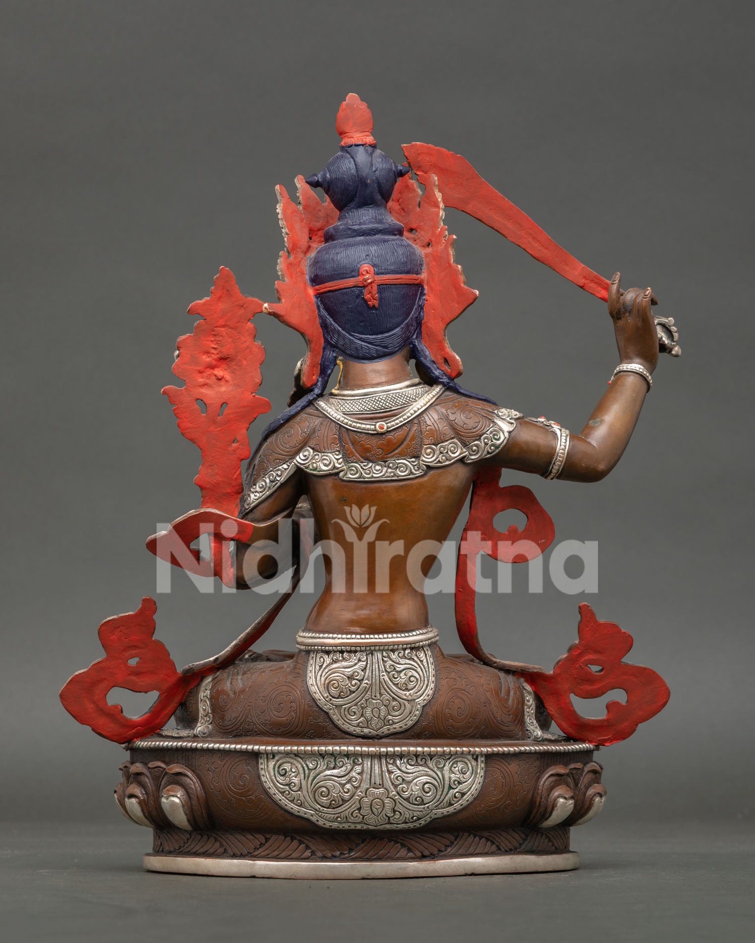 Back view of Manjushri statue revealing lost wax casting details and handcrafted Nepalese Buddhist metalwork