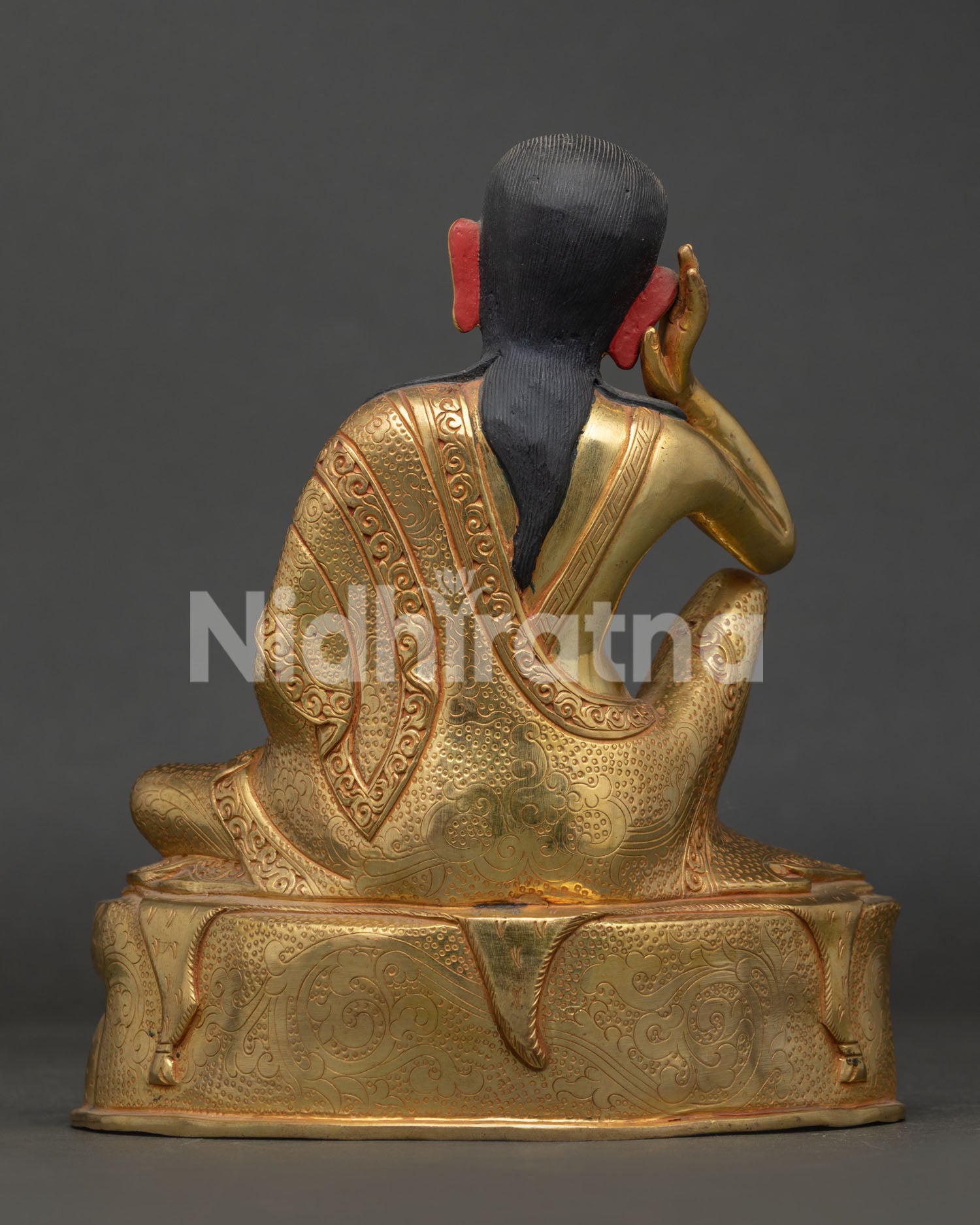 Back view of Milarepa statue featuring gold gilding details and Nepalese artisan craftsmanship.