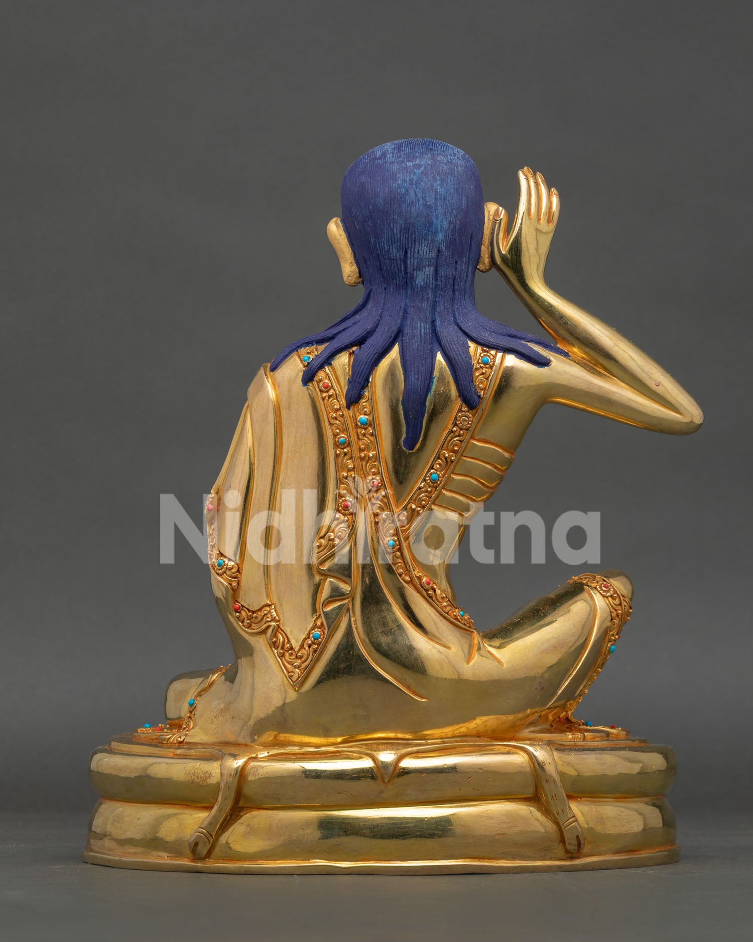 Back view of Milarepa statue, revealing detailed gilded robes and handcrafted Nepalese Buddhist artwork