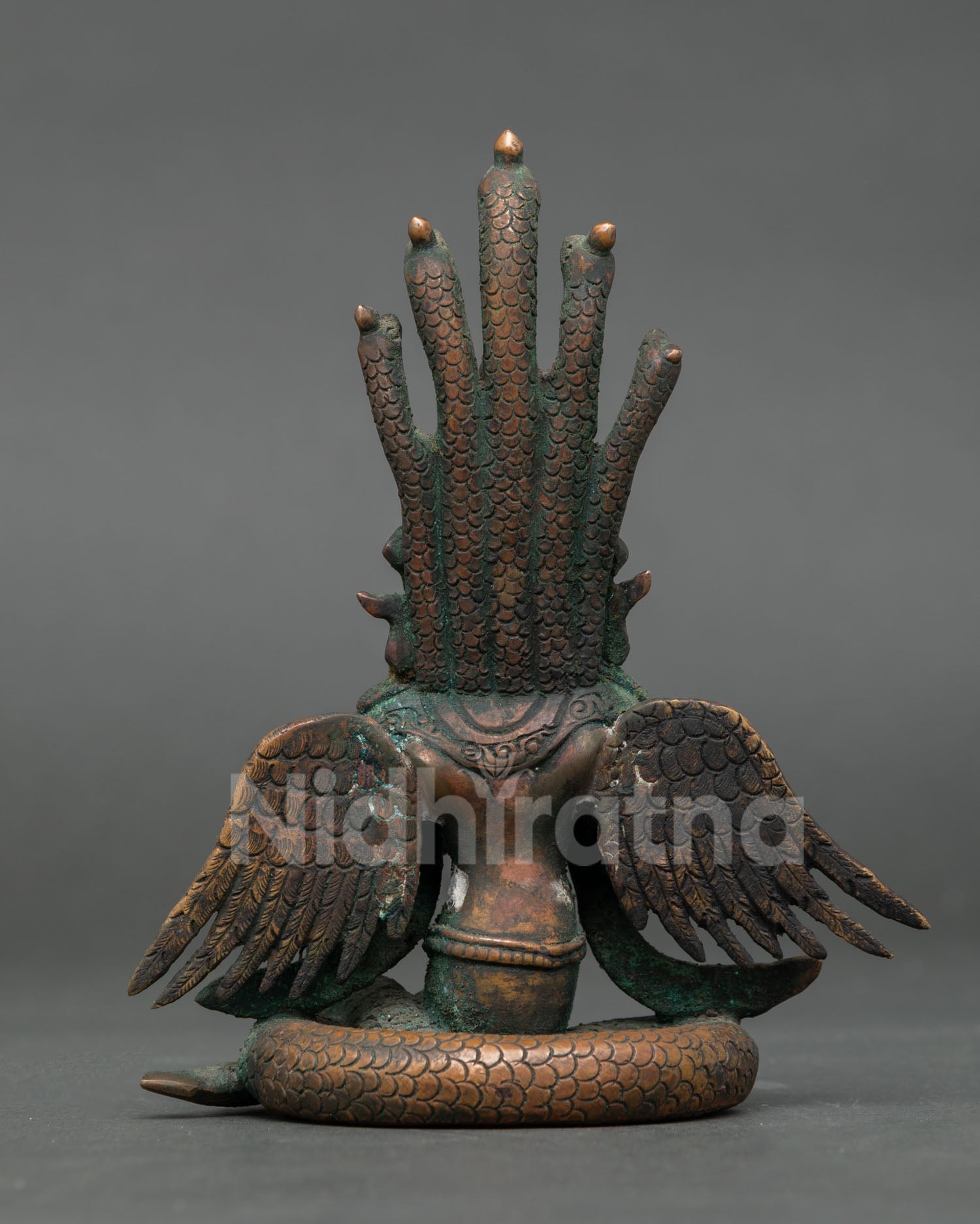 Back view of Nagakanya statue with detailed cobra hood and copper design