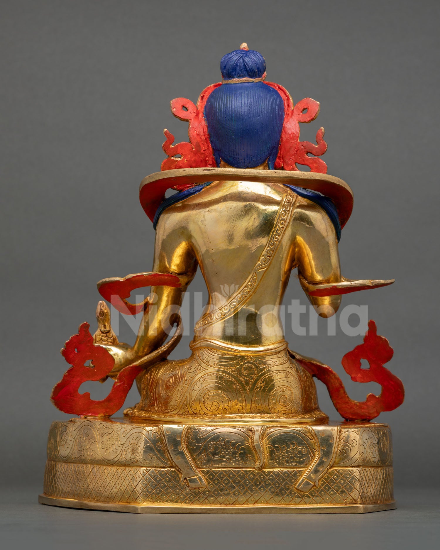 back view of naropa statue with engraved robe patterns and detailed cloud motifs