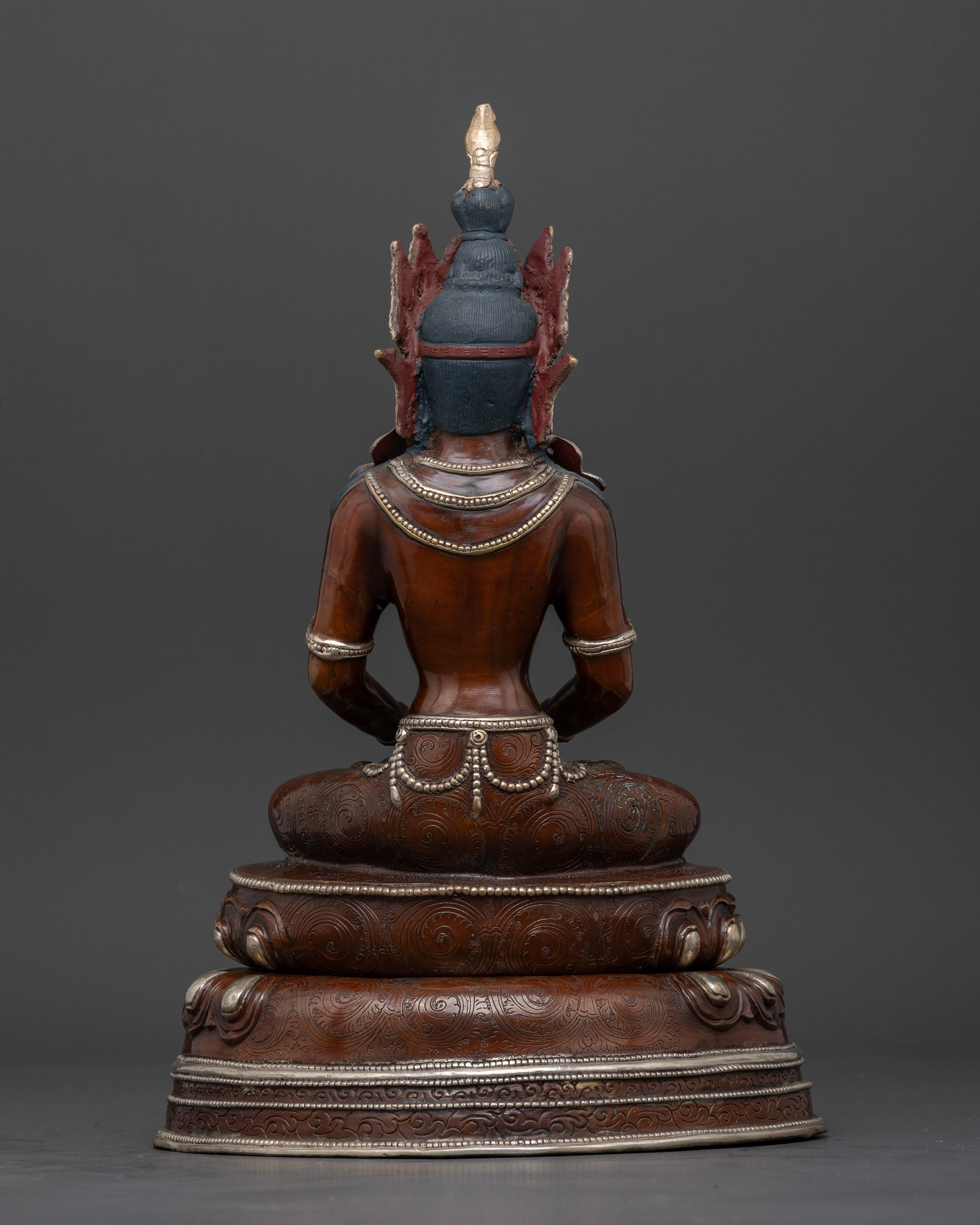 Back view of Nepalese Amitayus statue with oxidized silver plated finish and intricate details