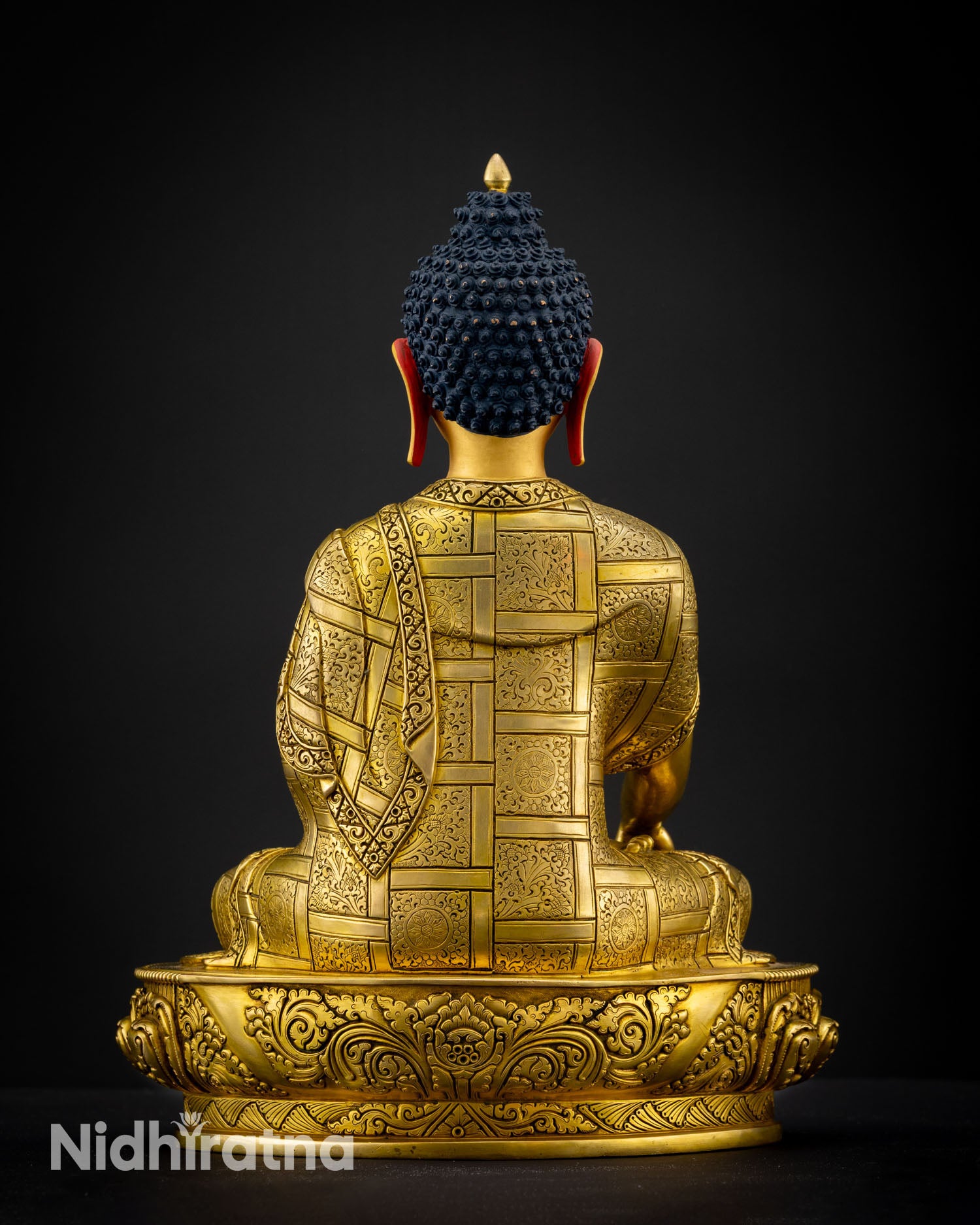 Back view of Nepalese Shakyamuni Buddha statue showing detailed robe patterns and copper artistry