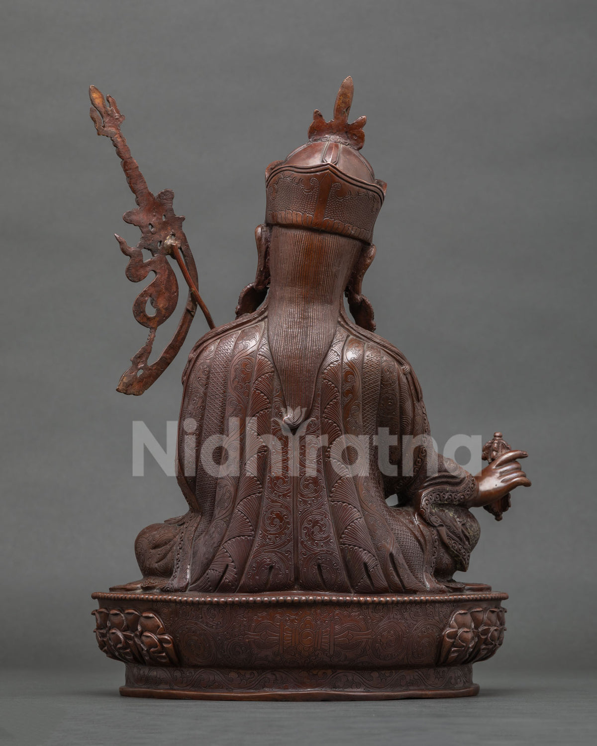 Back view of oxidized copper Guru Rinpoche statue showing robe detailing, handcrafted in Nepal
