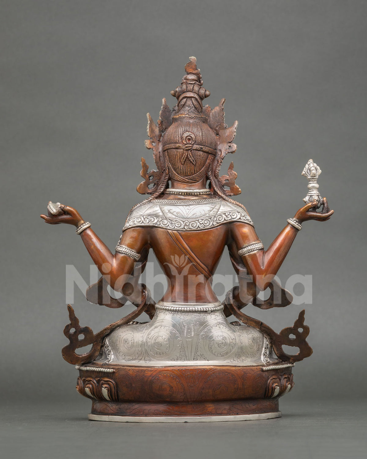 Back view of oxidized copper Prajnaparamita statue with engraved silver plating and lotus base