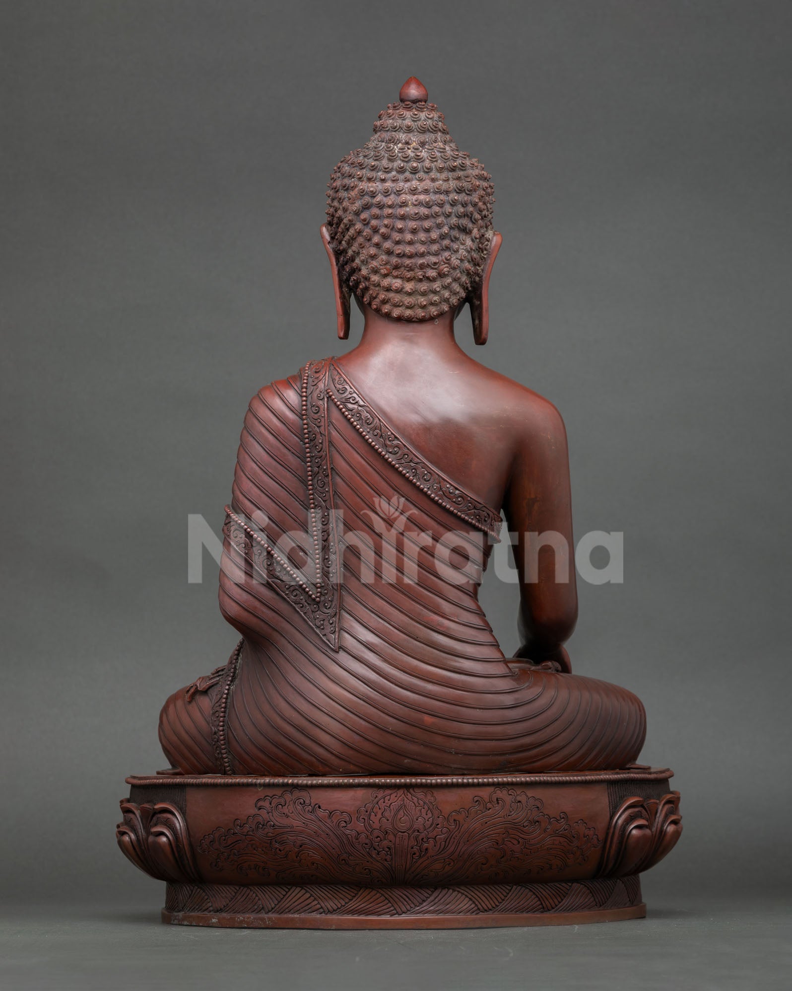 Back view of oxidized copper Shakyamuni Buddha statue detailed robe and lotus seat