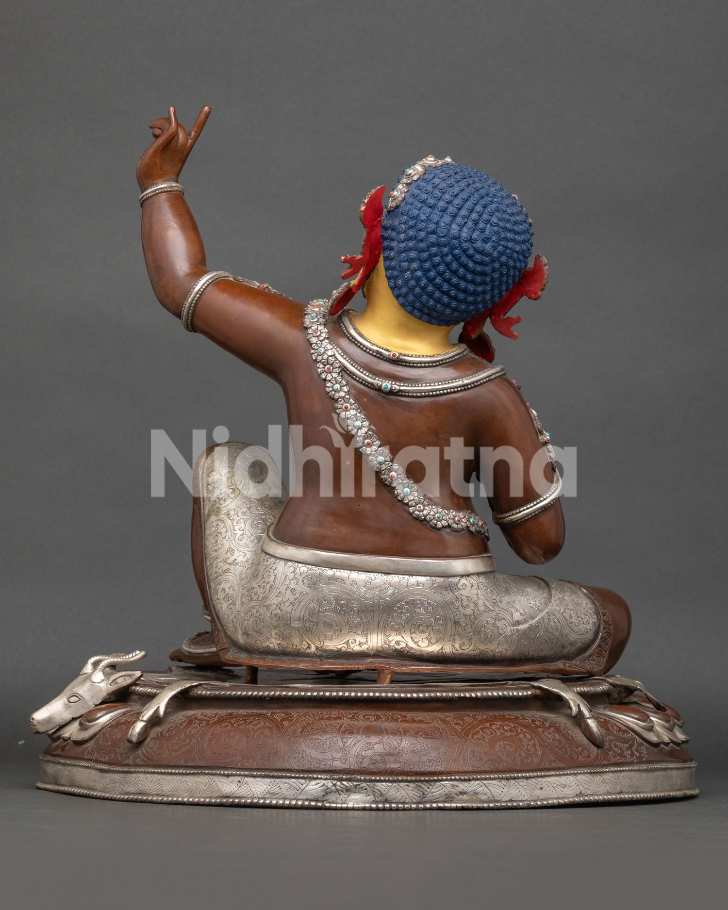 Back View of Oxidized Copper Virupa Statue Showing Ornate Jewelry, Floral Motifs, and Deer Skin Seat