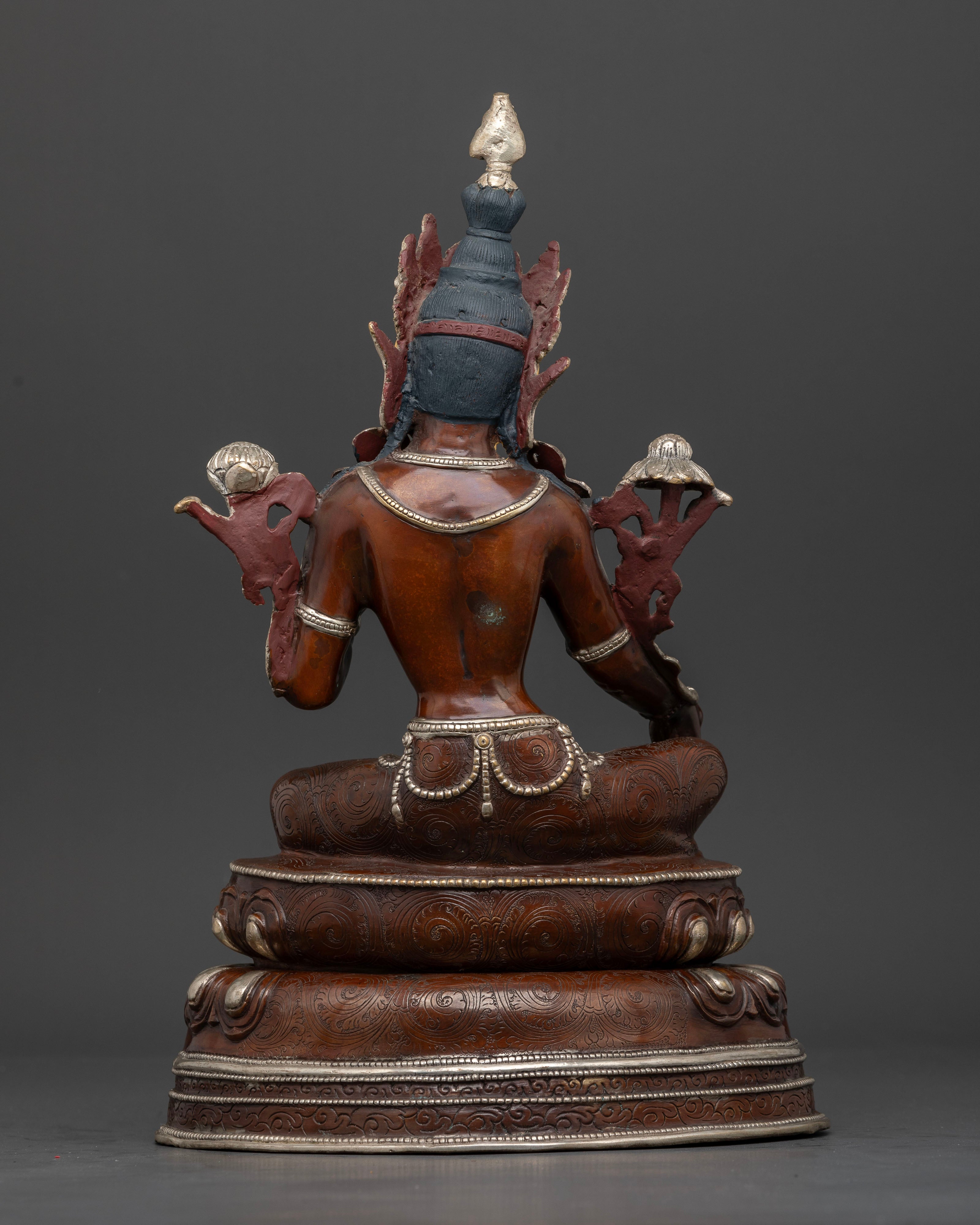 Back view of oxidized Green Tara statue showing intricate copper work and lotus pedestal.