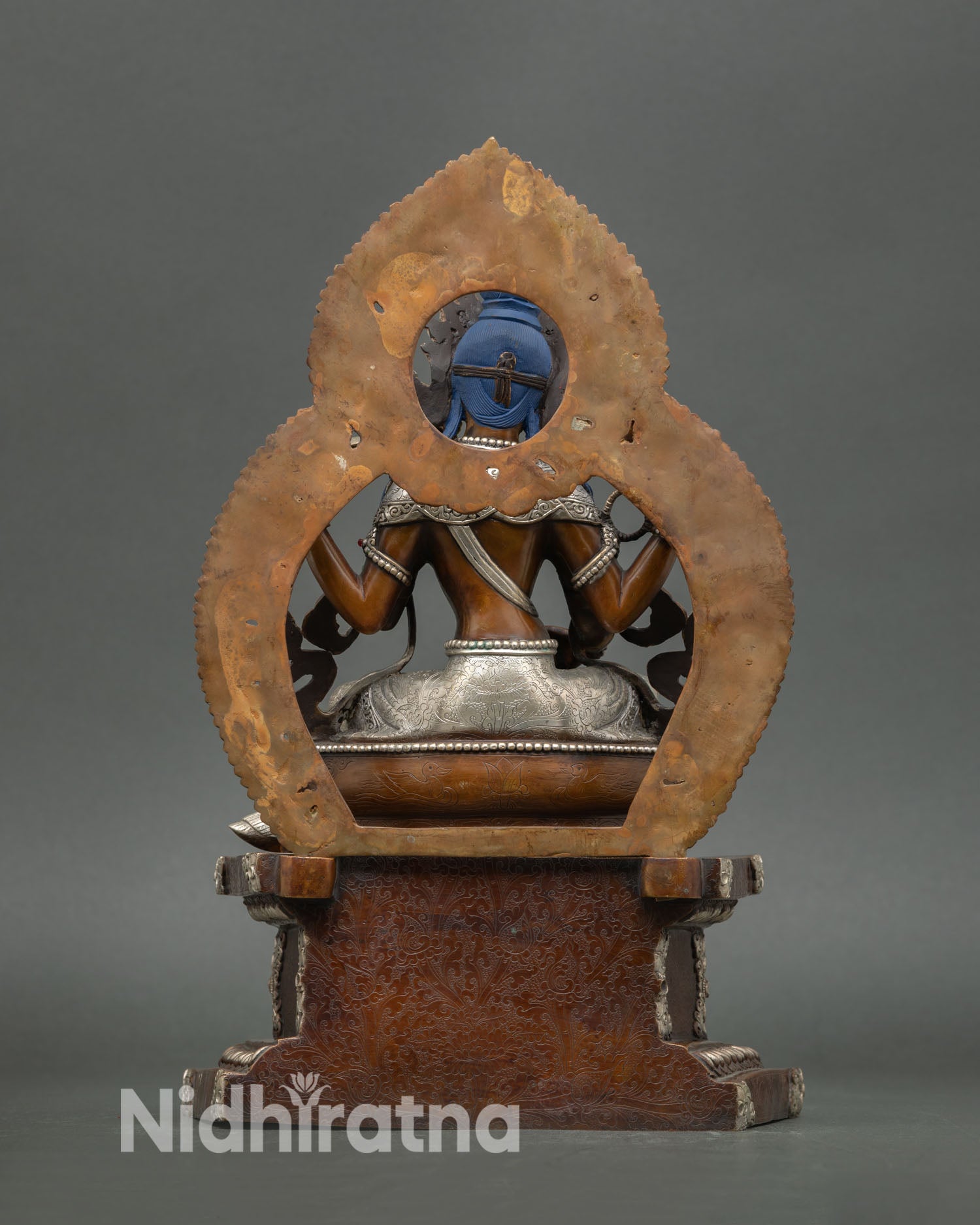 Back view of Saraswati statue highlighting oxidized copper finish and traditional lost wax Nepalese metal artistry