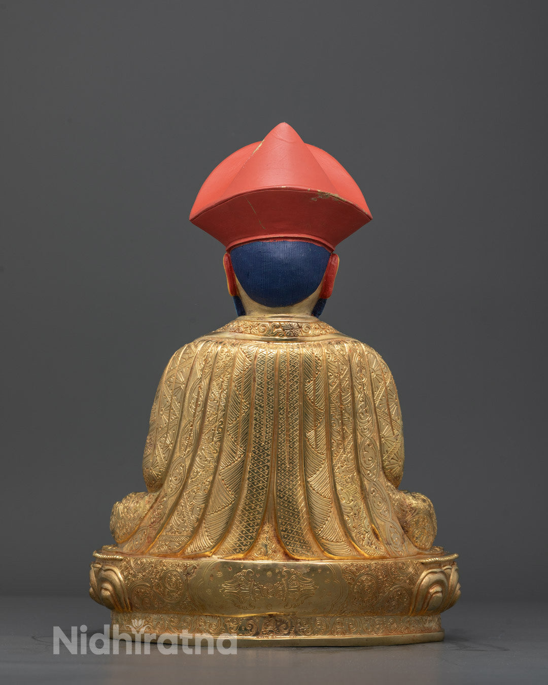 Back view of Shabdrung Rinpoche statue with engraved lotus base and copper-gold craftsmanship