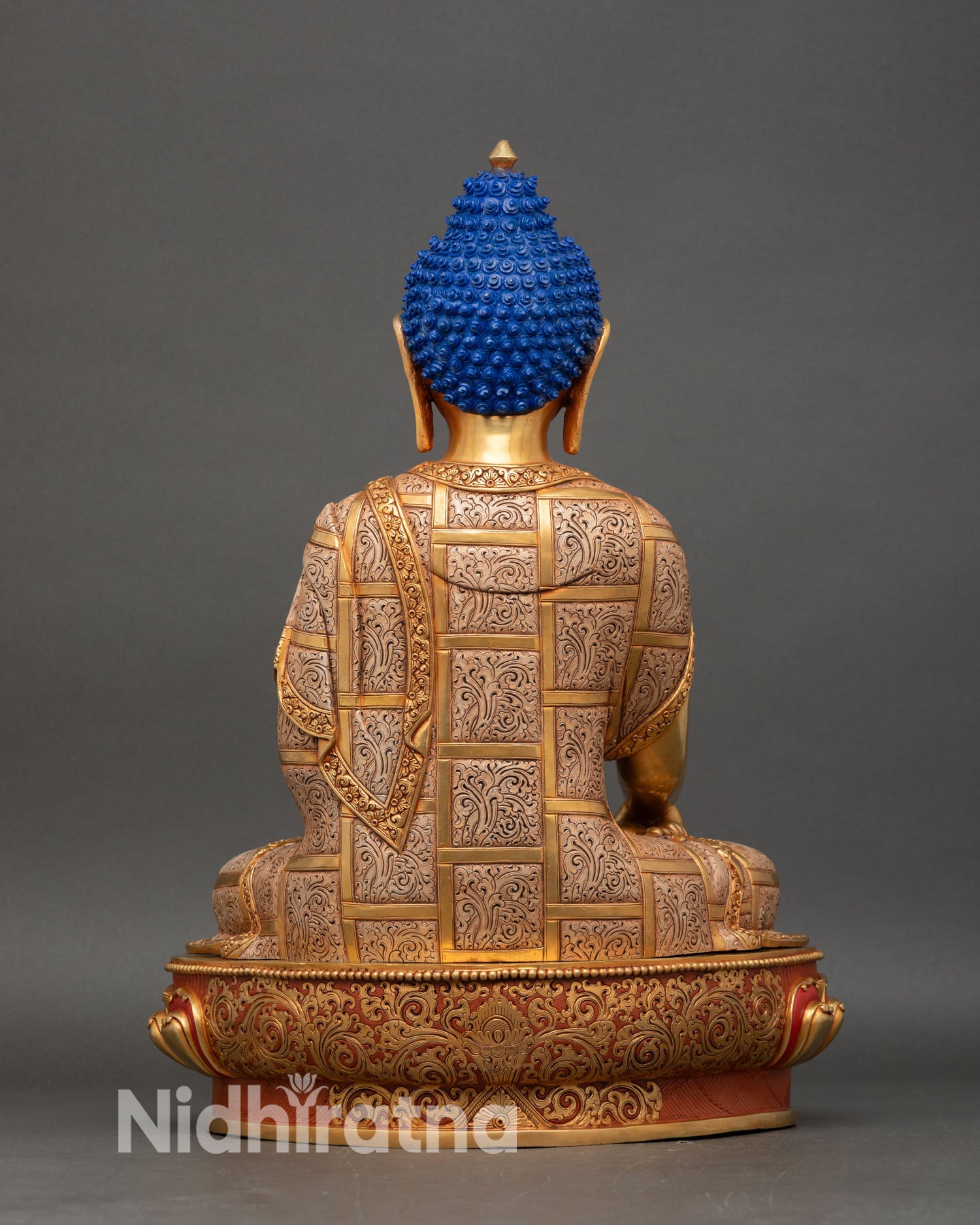 back view of shakya buddha statue showing lotus pedestal and intricate copper work