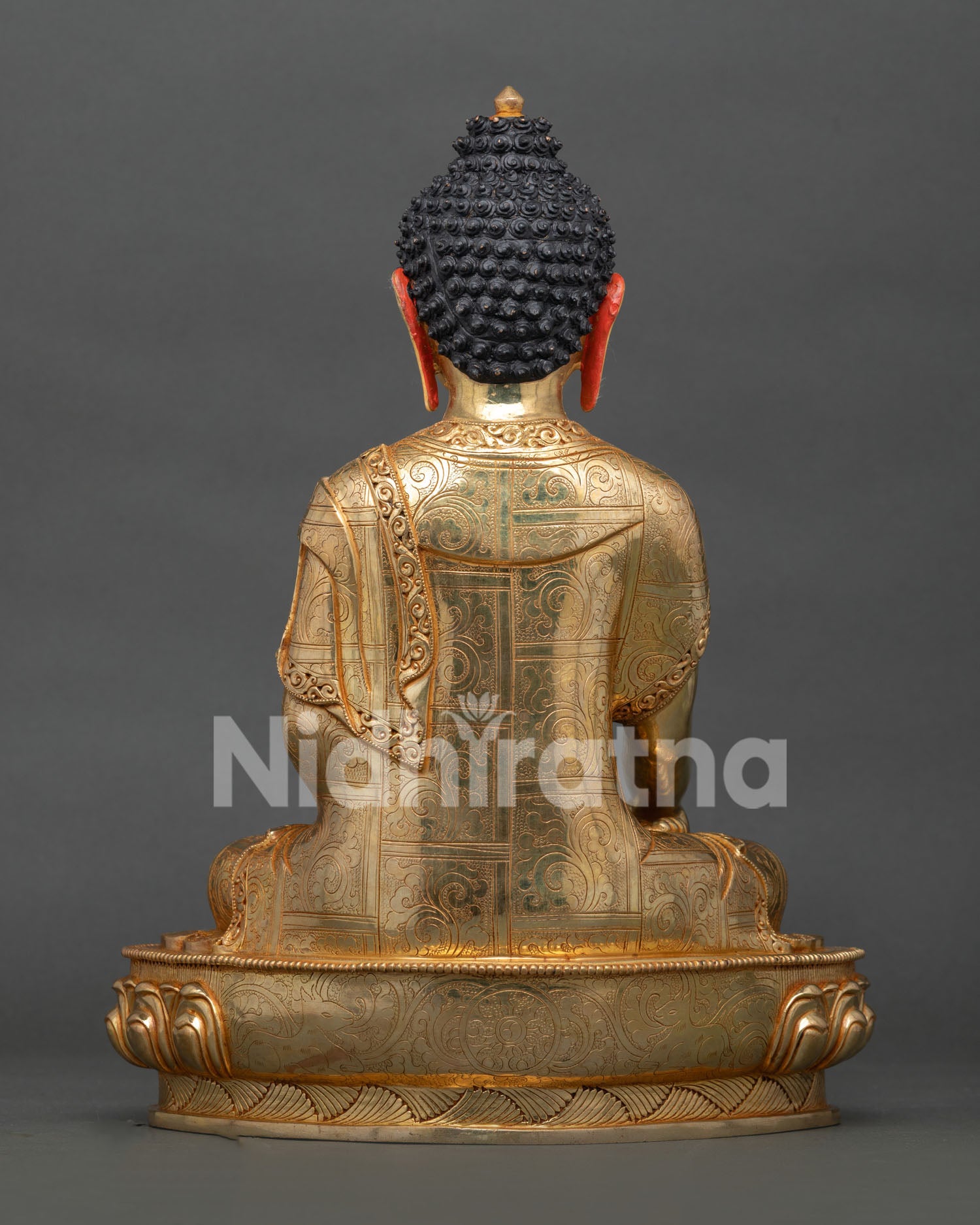 back view of shakyamuni buddha statue displaying detailed robe patterns and finish