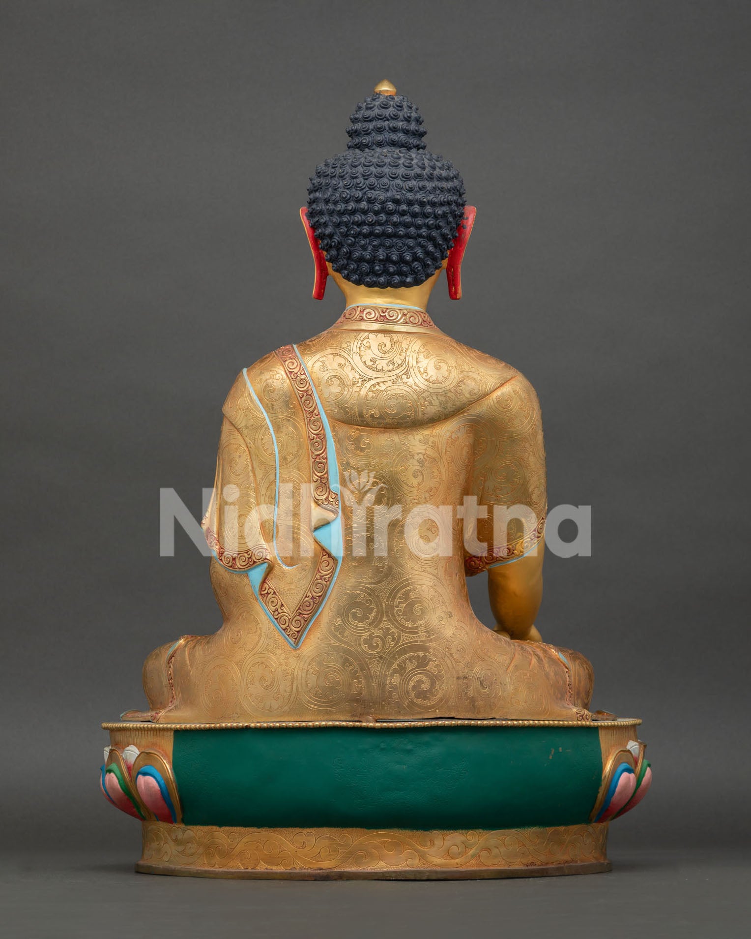 Back view of Shakyamuni Buddha statue, displaying traditional Himalayan metalwork artistry