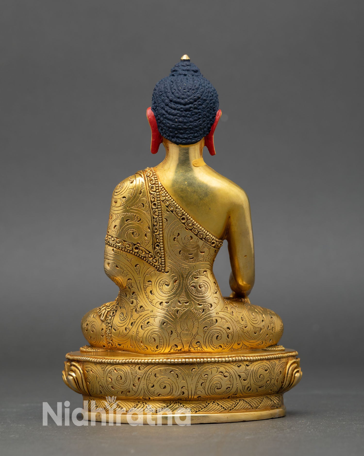 back view of shakyamuni buddha statue showing engraved patterns and sacred design