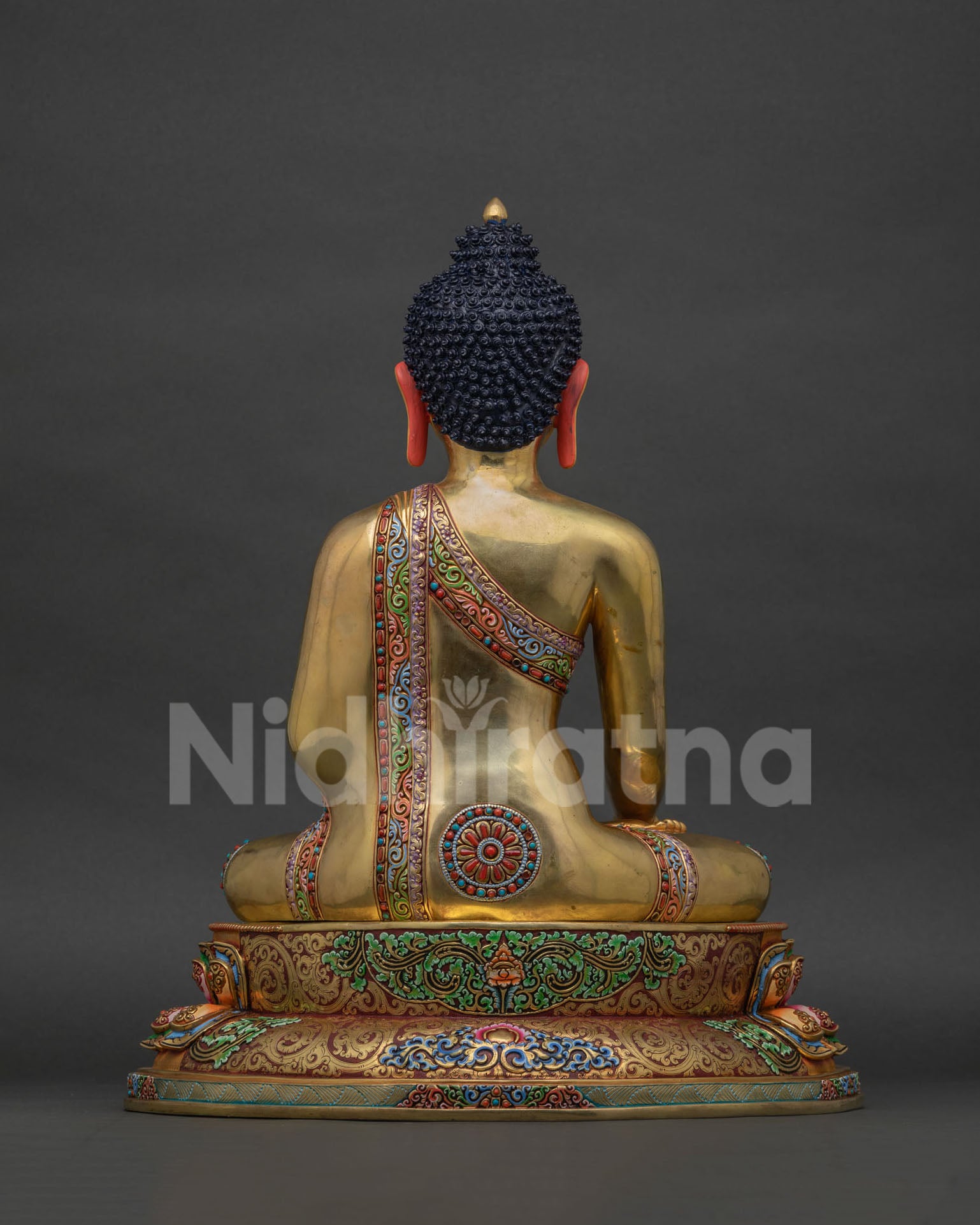 Back view of Shakyamuni Buddha statue Bangkok showing gold-gilded robe and lotus seat detailing