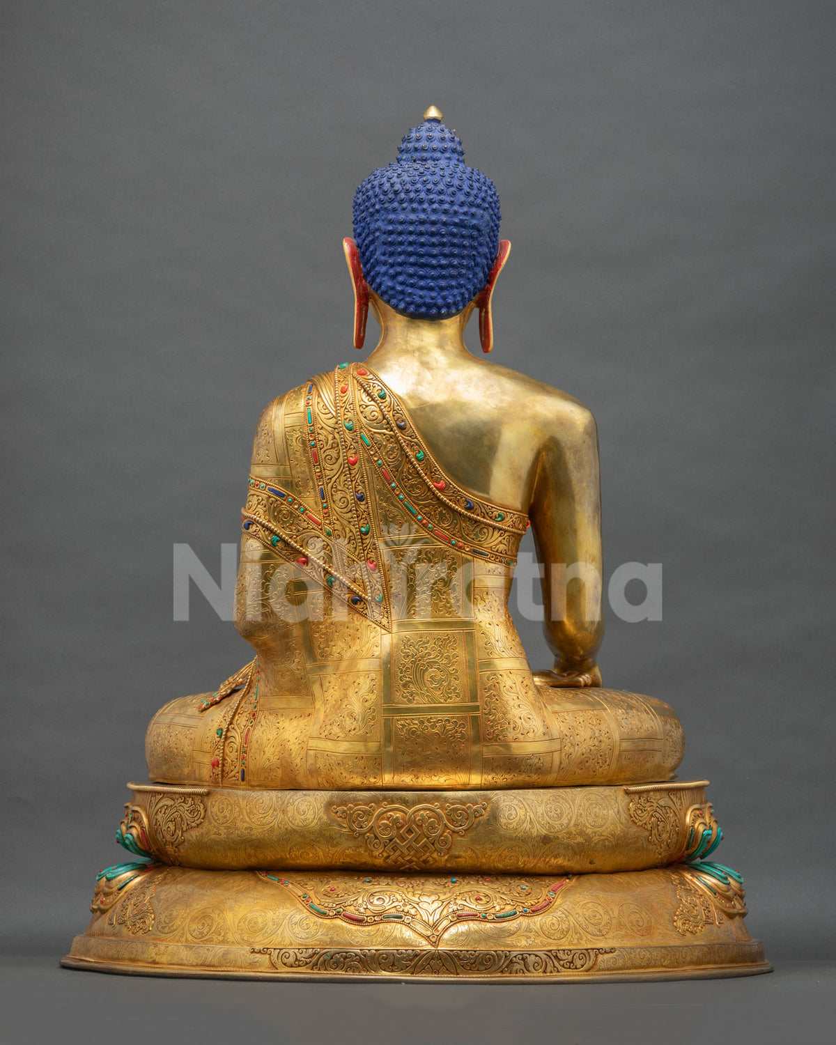 Back view of Shakyamuni Buddha statue with hand-chased robe and repoussé patterns