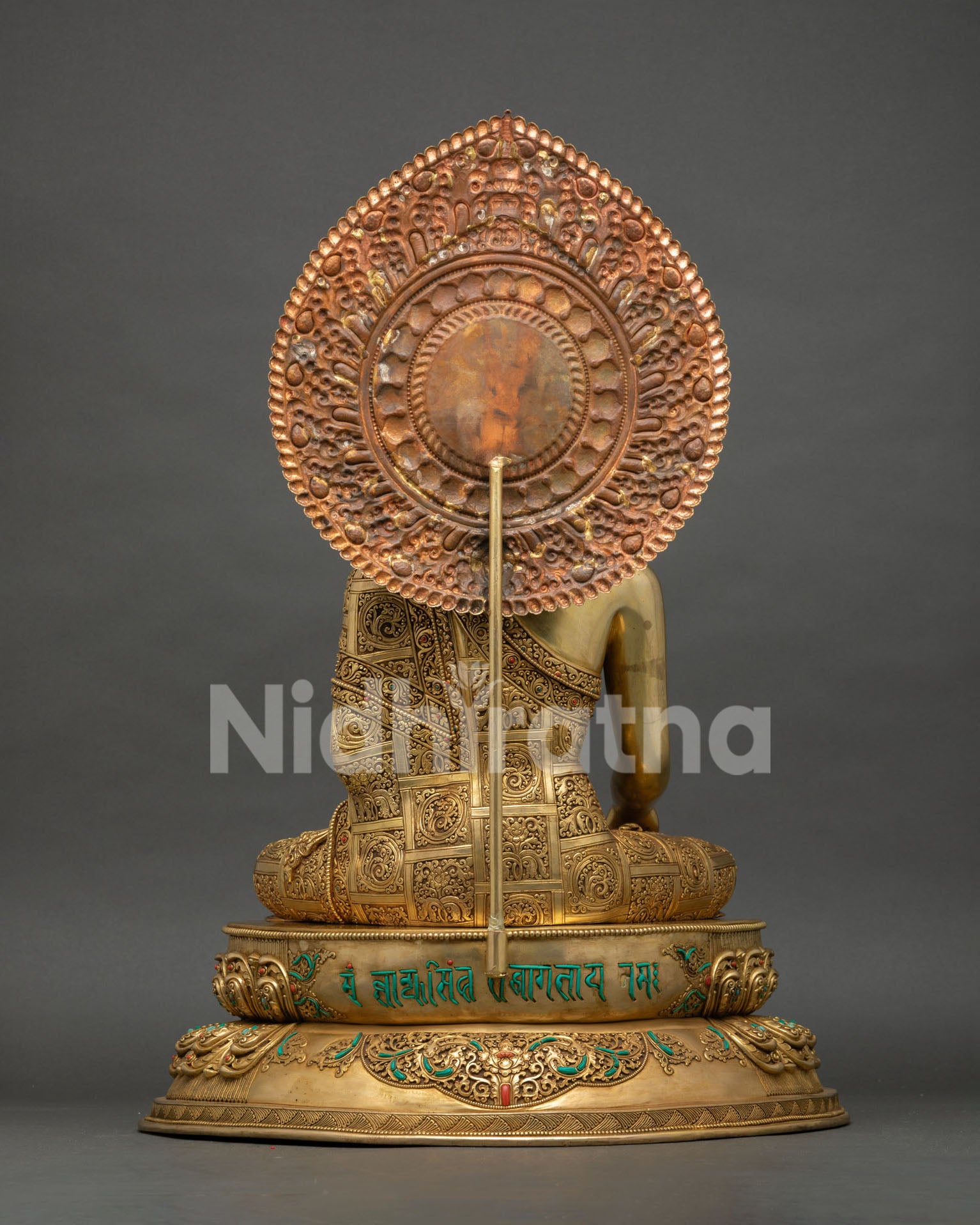 back view of shakyamuni buddha statue with ornate halo and handcrafted copper alloy design