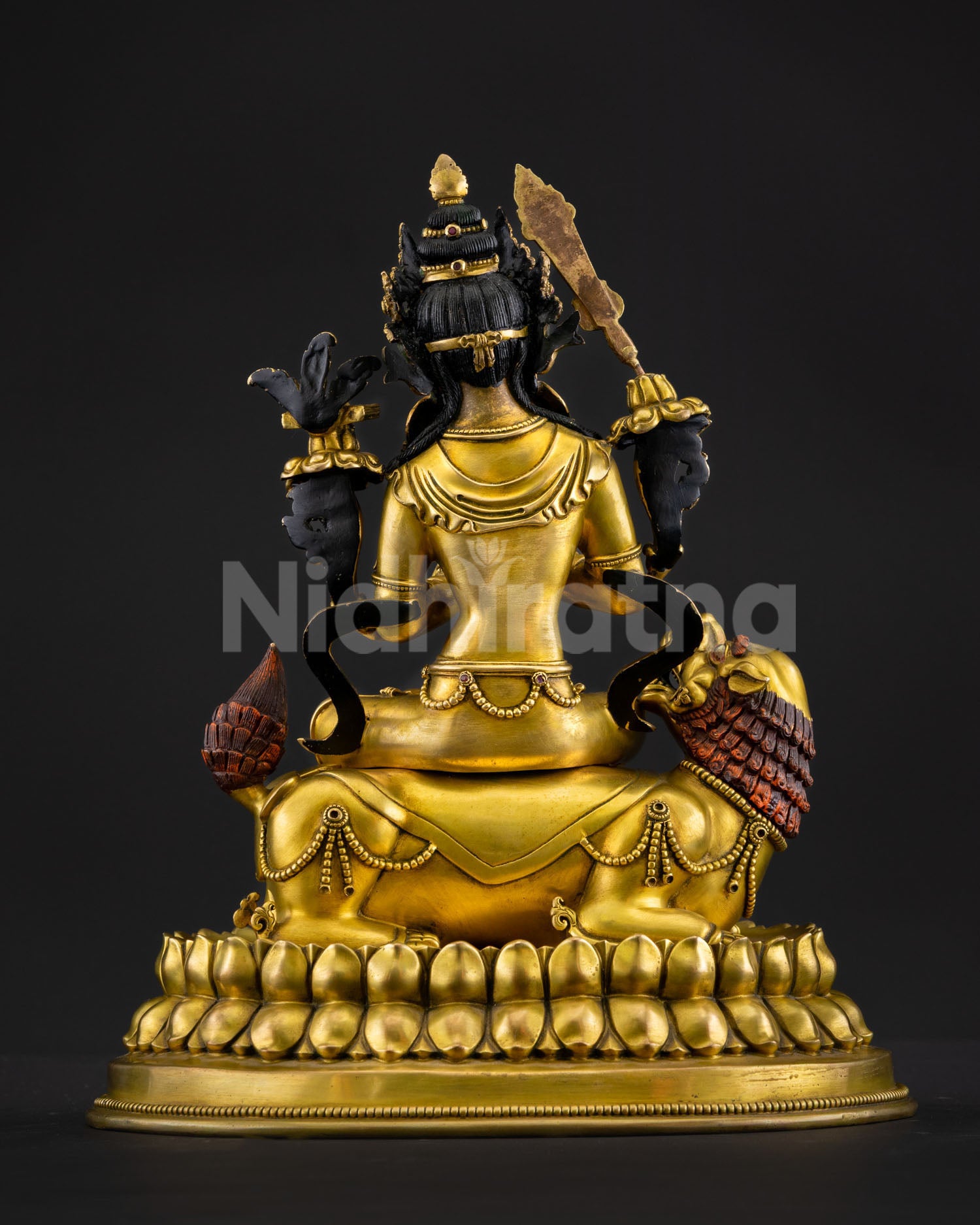 Back view of Simhanada Manjushri statue with ornate lotus throne detailing