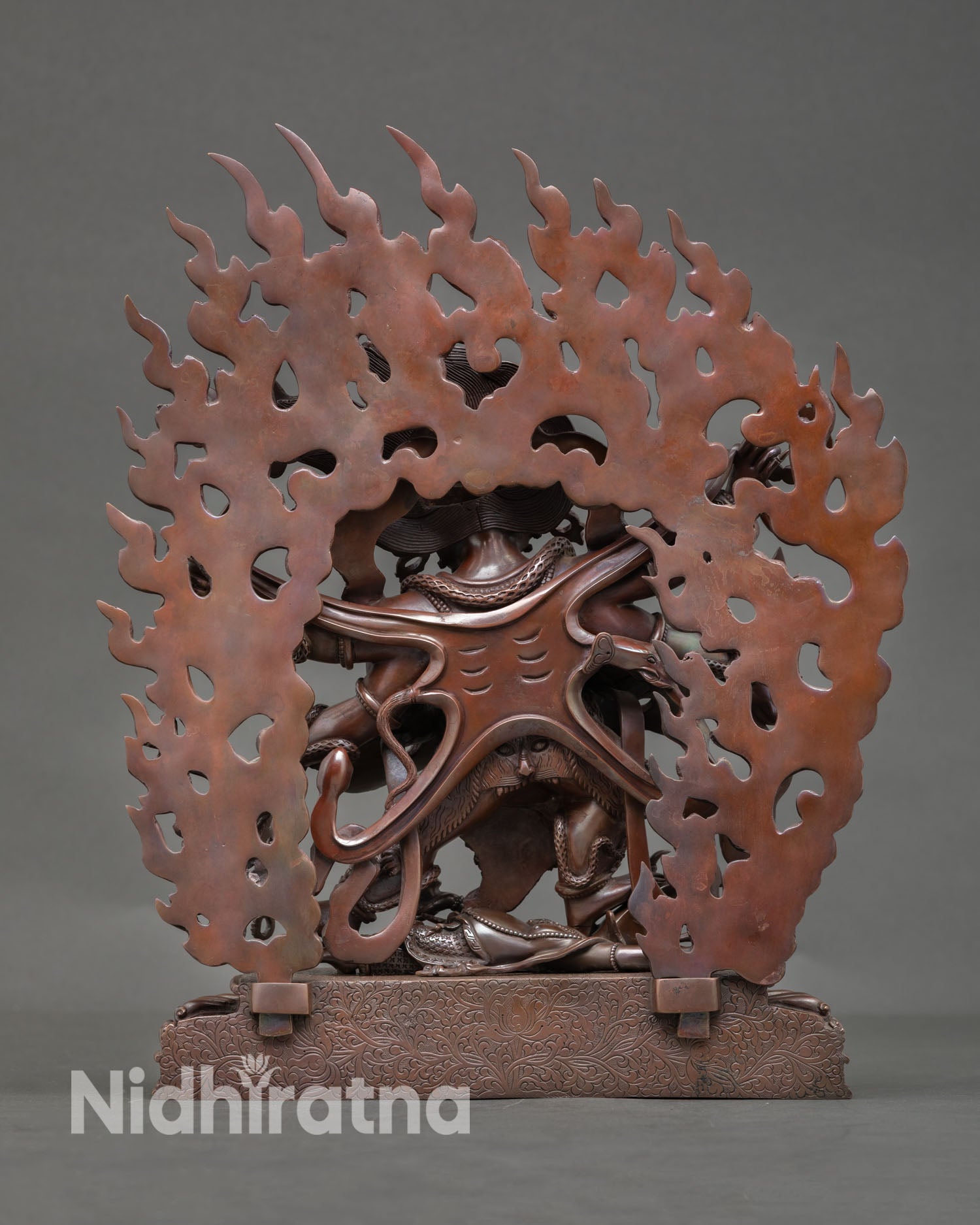 Back view of Six Armed Mahakala statue on lotus pedestal, flame halo, traditional Nepal Buddhist deity sculpture for home shrine and altar decor