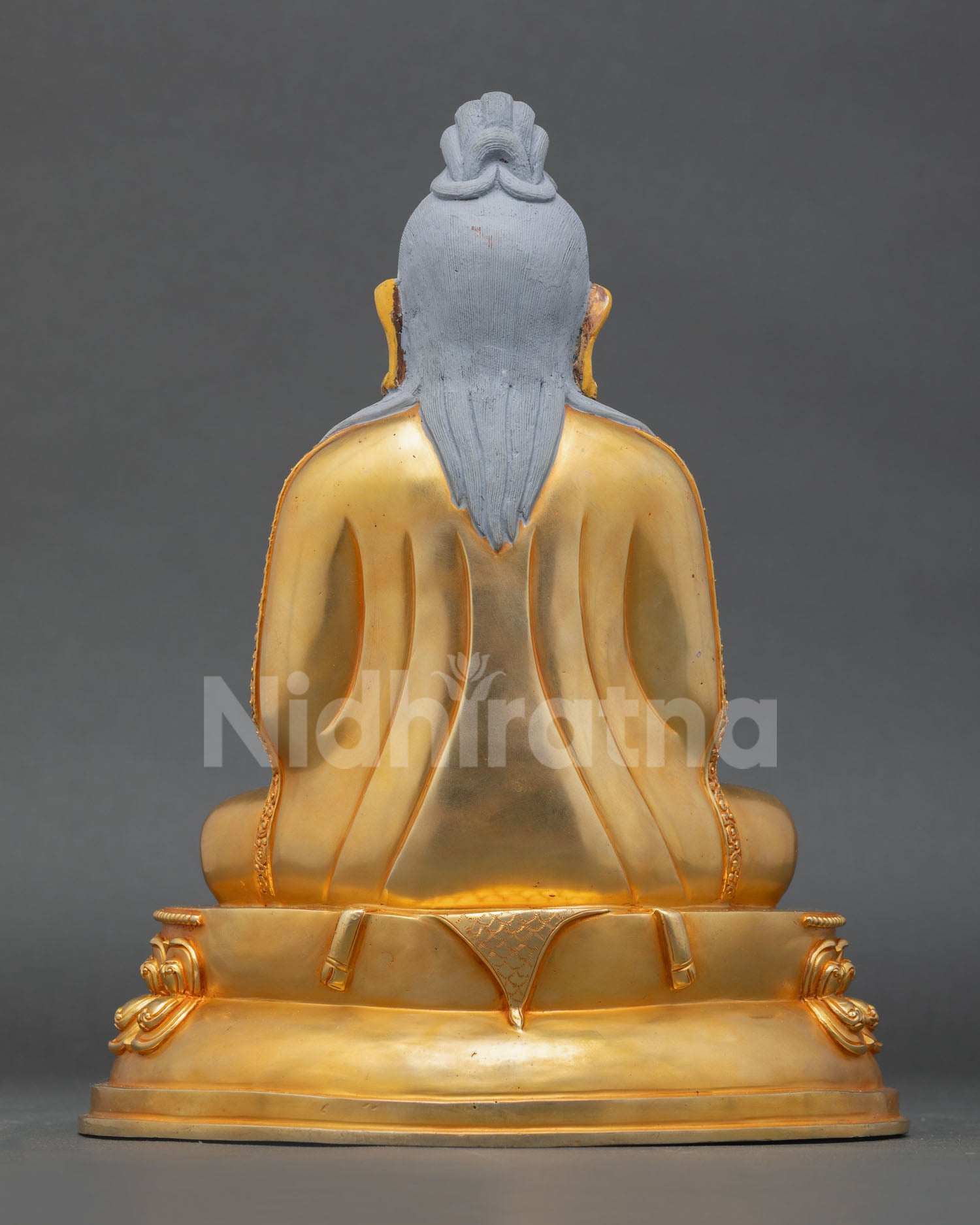 back view of thangtong gyalpo statue with intricate nepalese metalwork