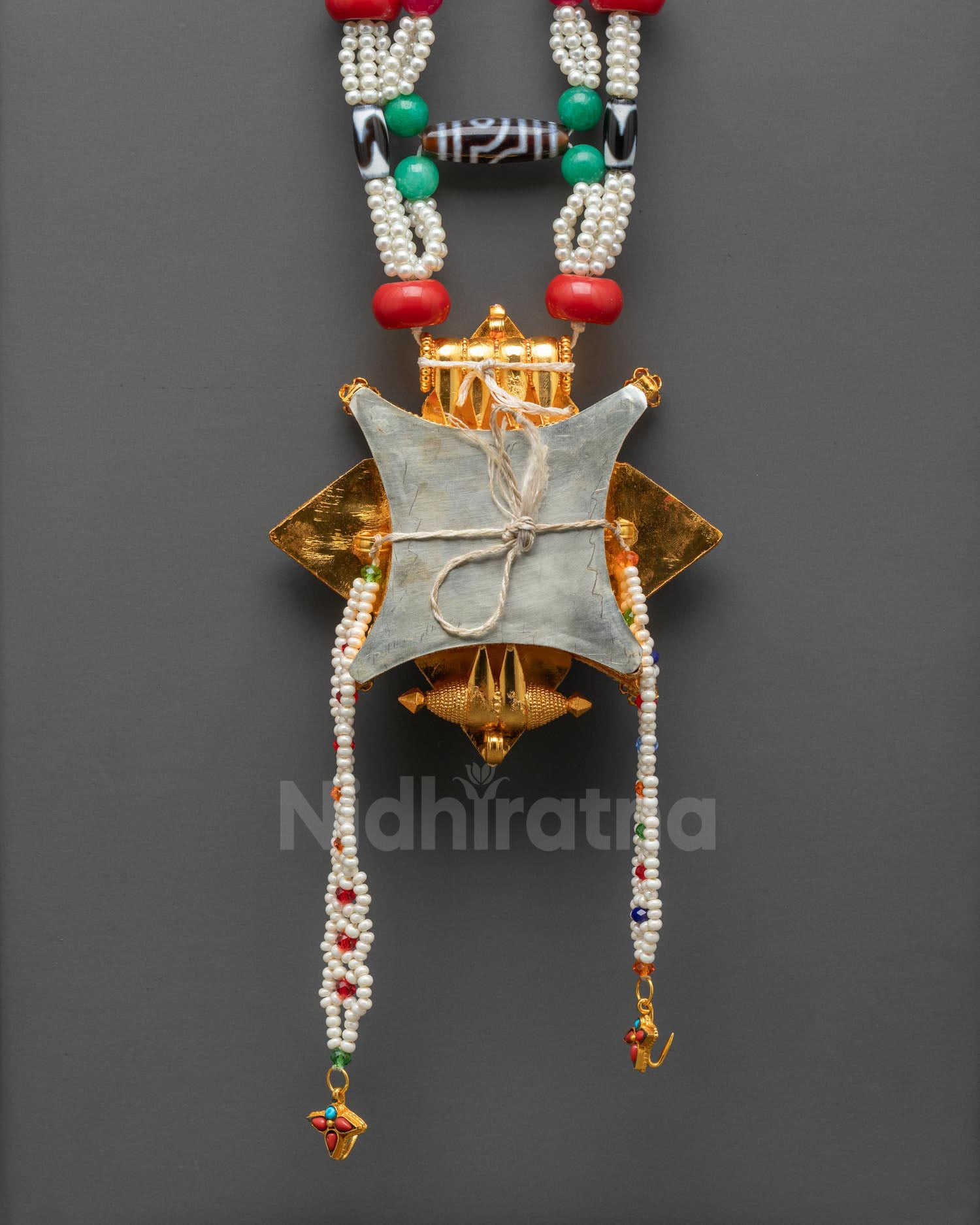 Back view of Tibetan Ghau Mala sacred necklace showing detailed craftsmanship and traditional Himalayan amulet design
