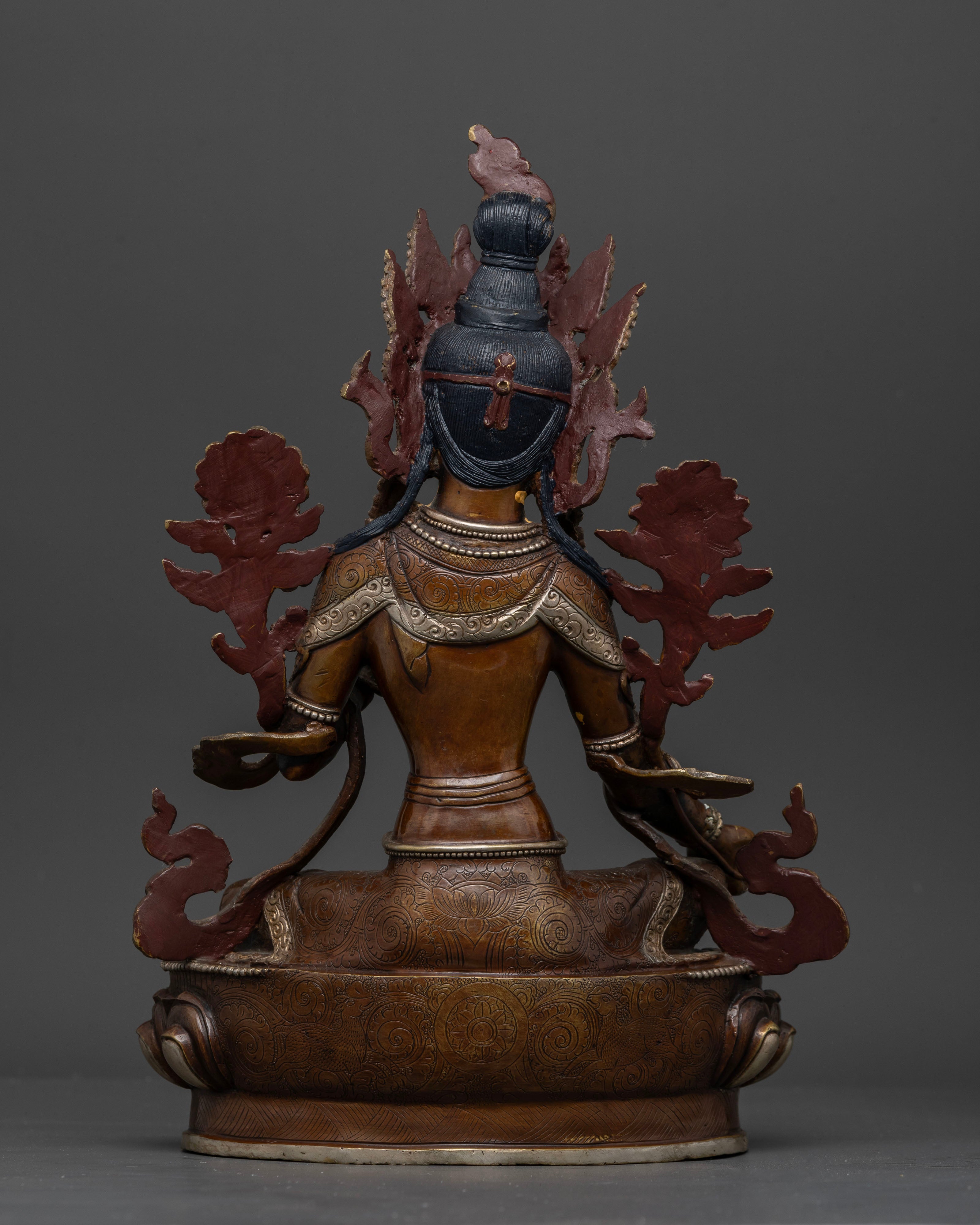 Back view of traditional Nepalese Green Tara sculpture with intricate details