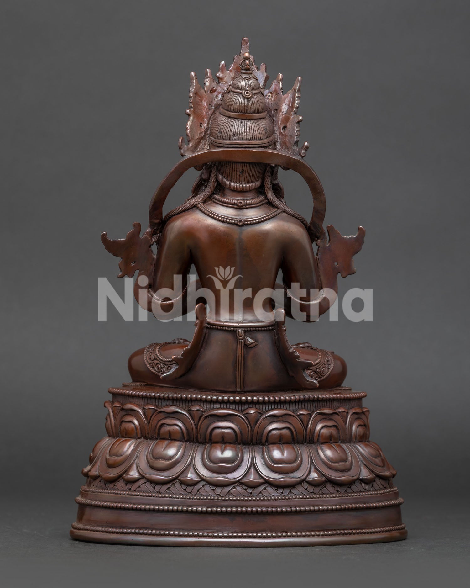Back view of traditional Nepalese Vajradhara Buddhist sculpture with lotus pedestal