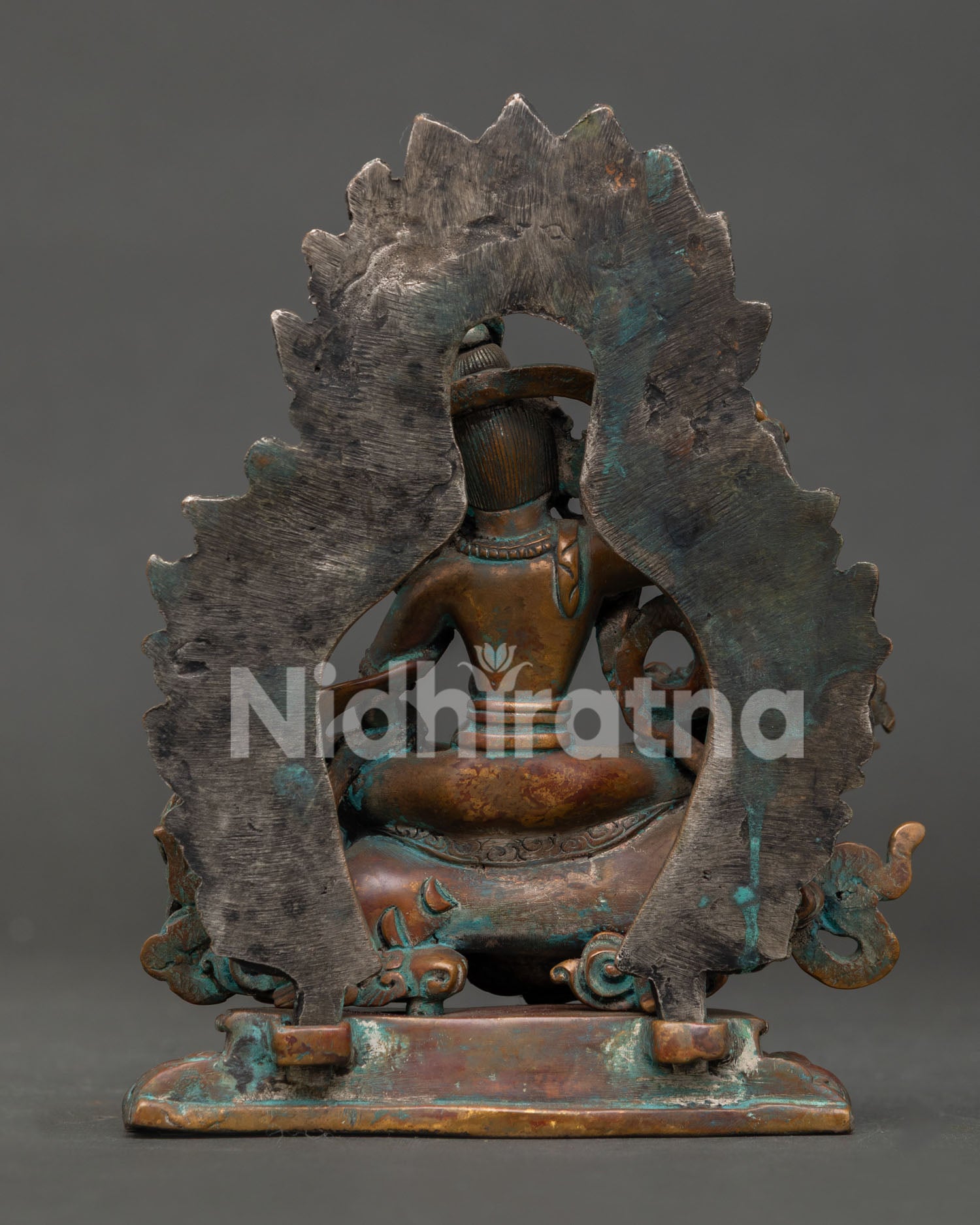 back view of tseringma statue showing detailed copper craftsmanship and design