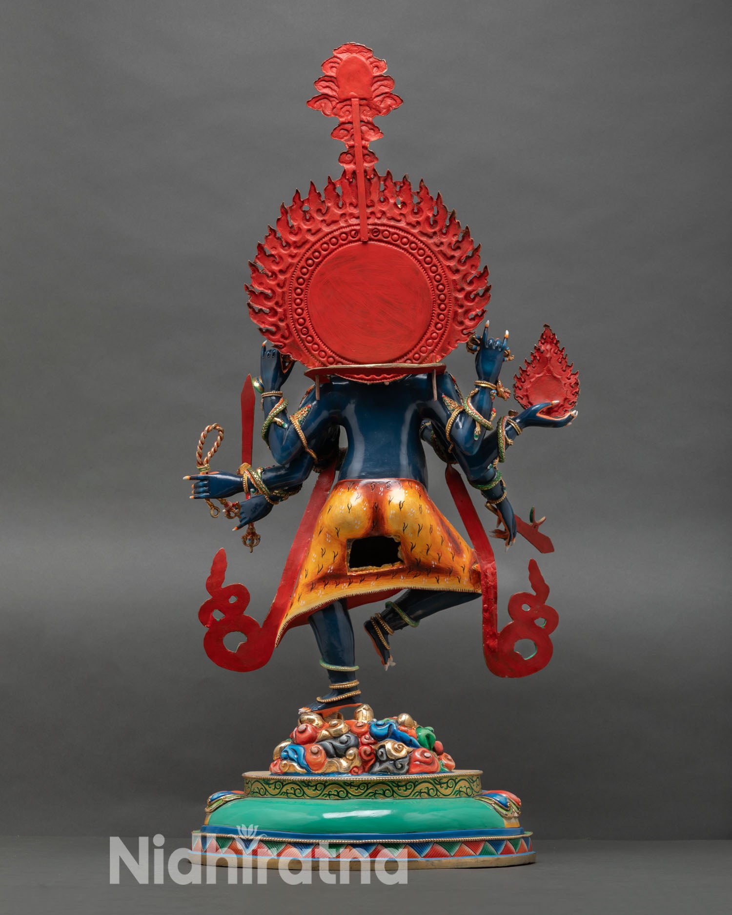 Back view of Ucchusma statue highlighting intricate copper alloy detailing, dynamic posture