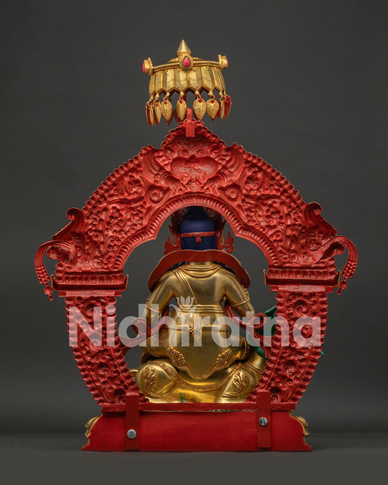 Back view of Vaisravana Namtoshe statue showing intricate metal carving and fire-gilding