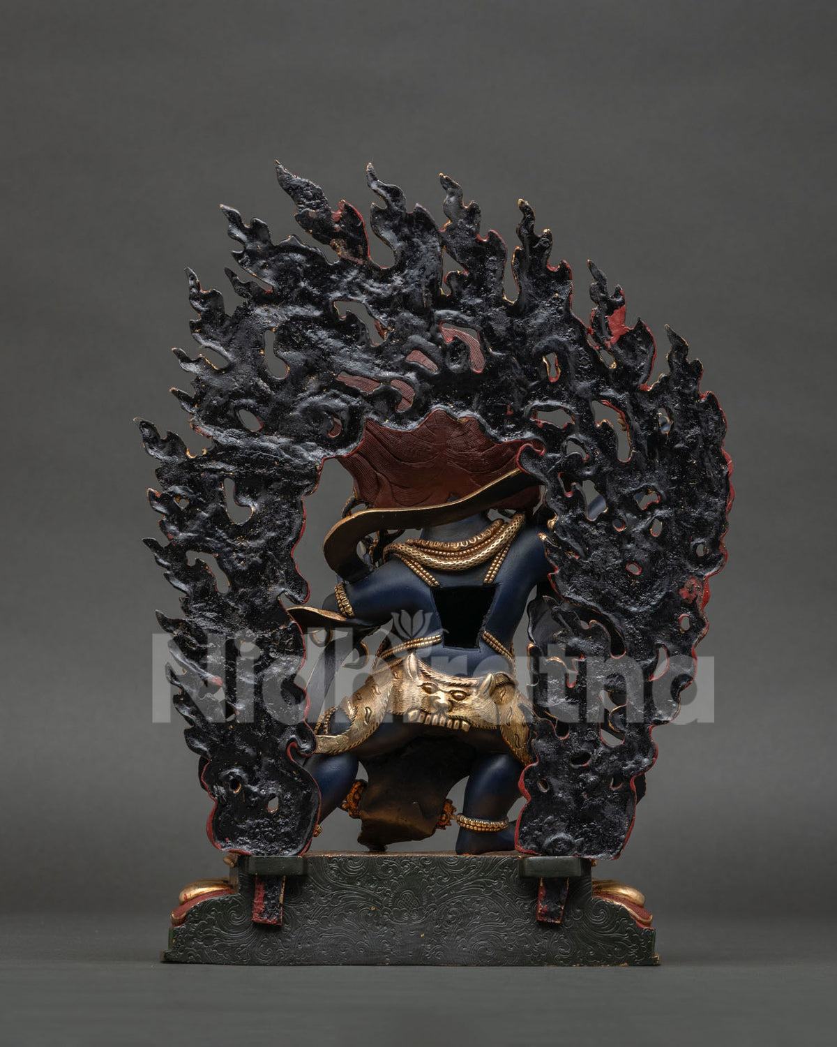 Back view of Vajrapani Statue showing hand-carved flame halo detailing