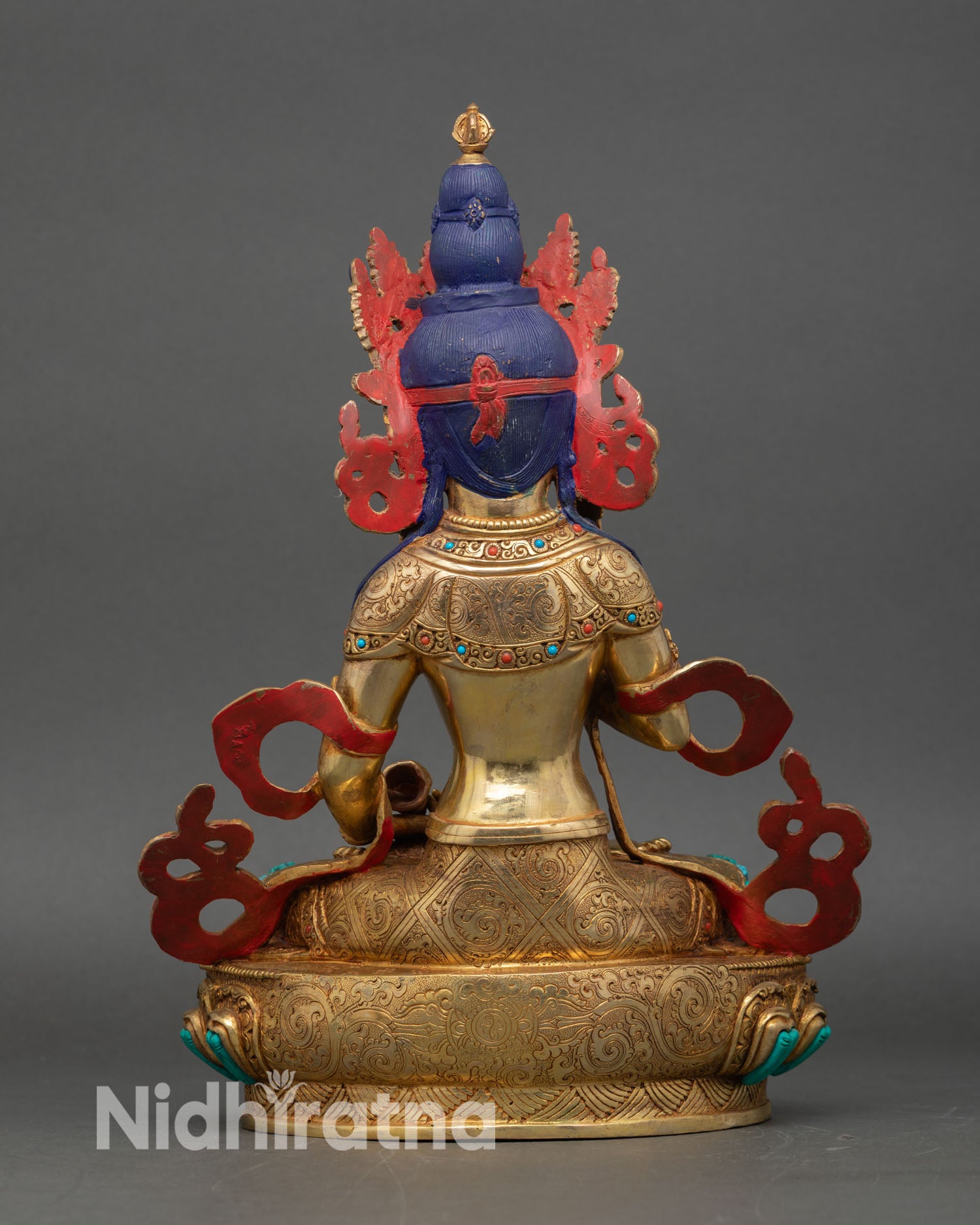 Back view of Vajrasattva sculpture, showing lotus seat, carvings, and traditional Tibetan craftsmanship