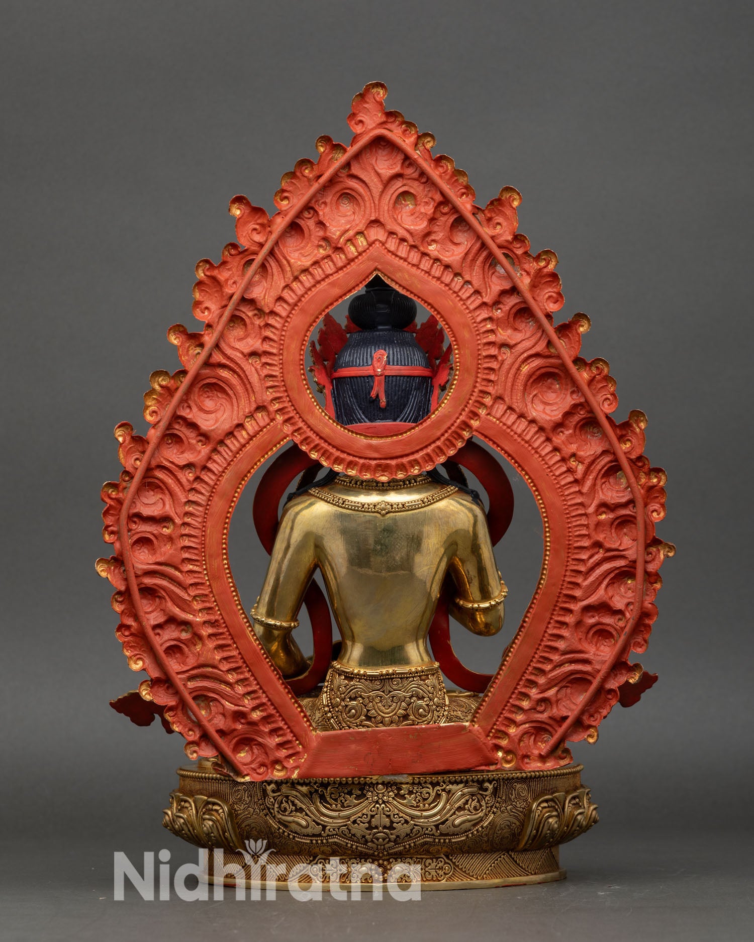 back view of vajrasattva statue showing engraved lotus pedestal and flame pinnacle