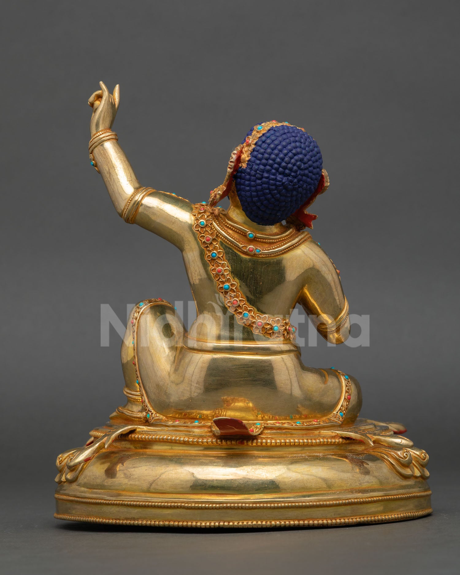 Back view of Virupa Mahasiddha statue with ornate lotus seat deer skin motif and Nepal craftsmanship