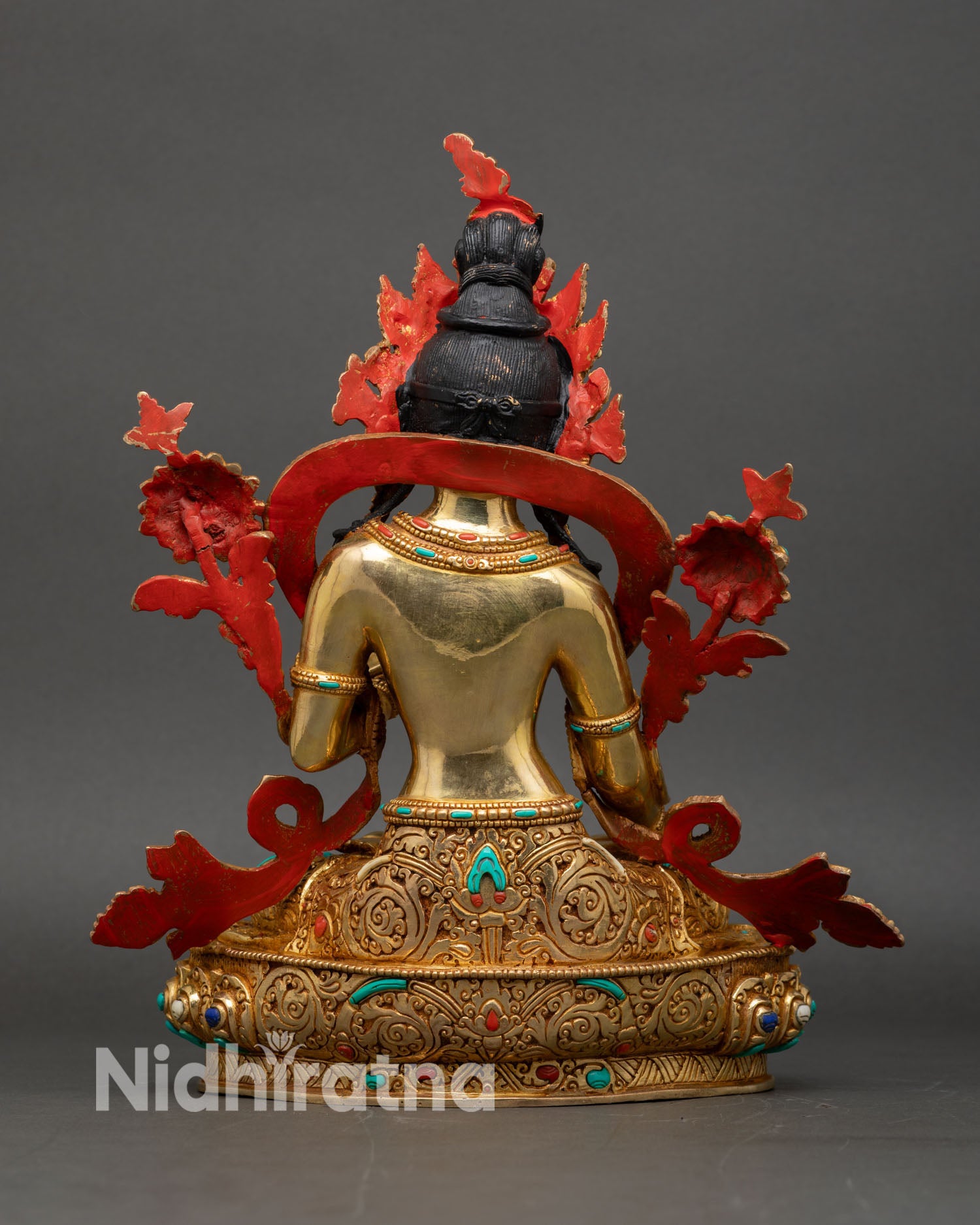 Back view of white tara seven eyed statue showing lotus pedestal and intricate craftsmanship