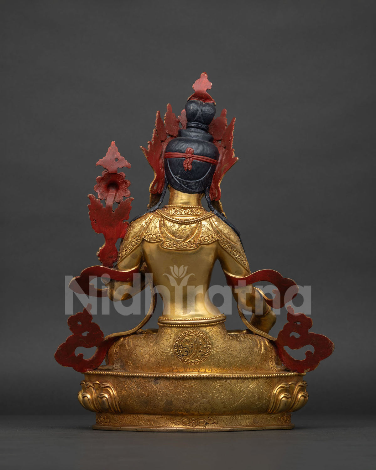 Back view of White Tara statue showing lotus throne and robe detail