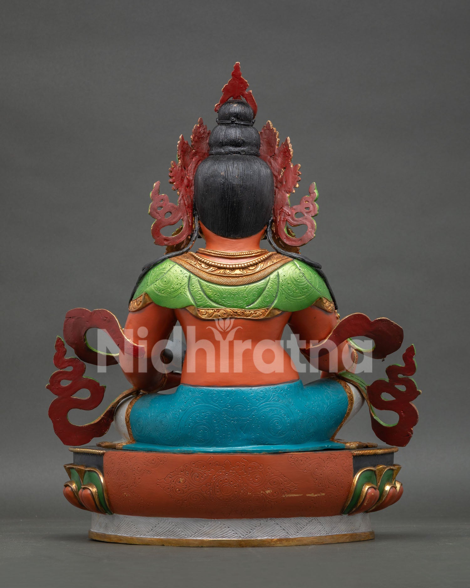 back view of yellow dzambhala statue displaying detailed robes, ornaments and lotus pedestal craftsmanship