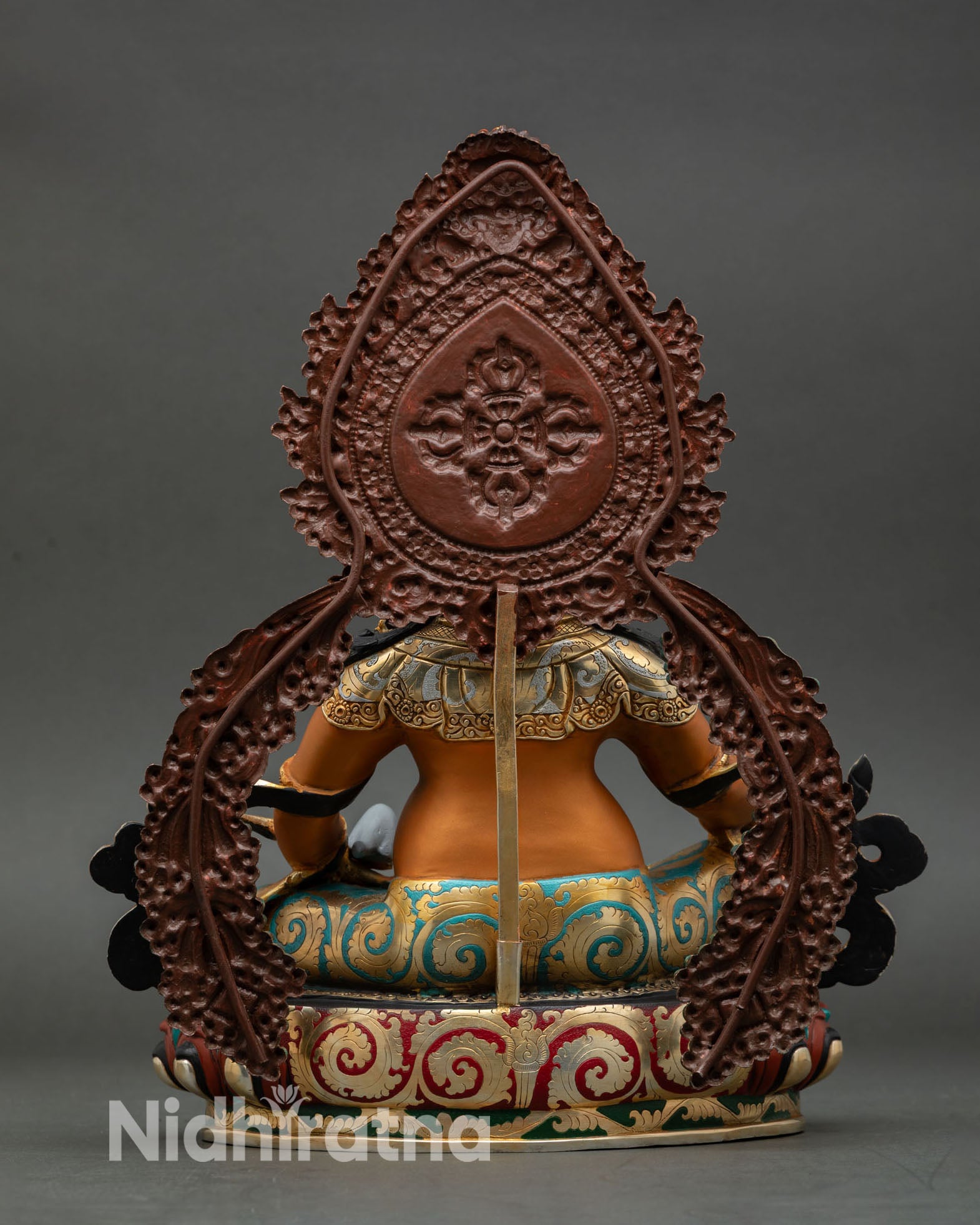 back view of yellow dzambhala statue showing detailed copper craftsmanship gold gilded patterns and sacred decorative elements