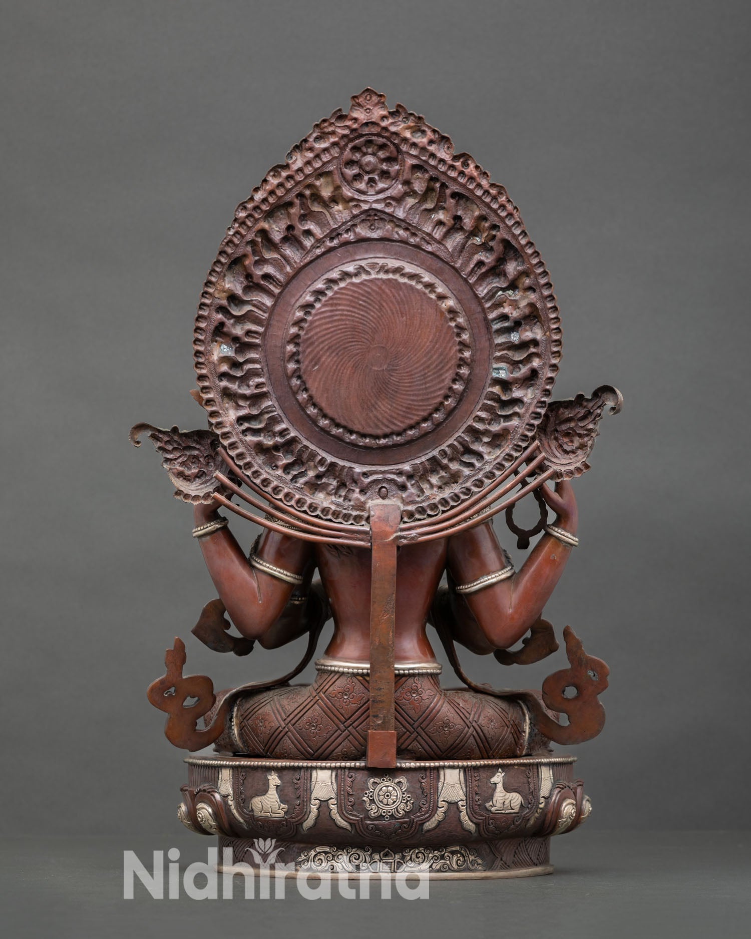 Back view of sacred Chenrezig Buddhist sculpture with ornate halo and traditional Nepal craftsmanship