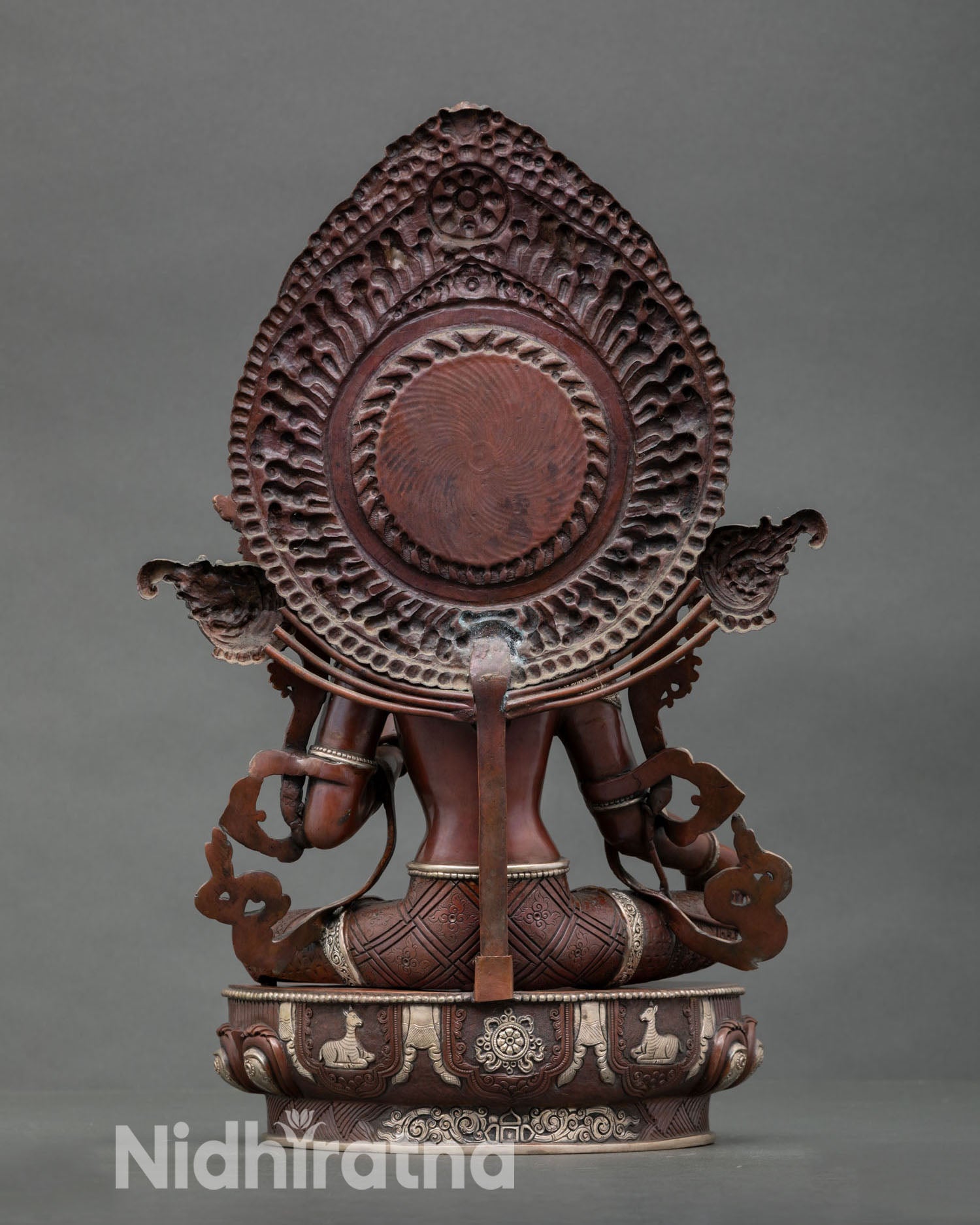 Back view of sacred Green Tara sculpture with detailed robes silver accents and traditional Newari craftsmanship for Buddhist shrine