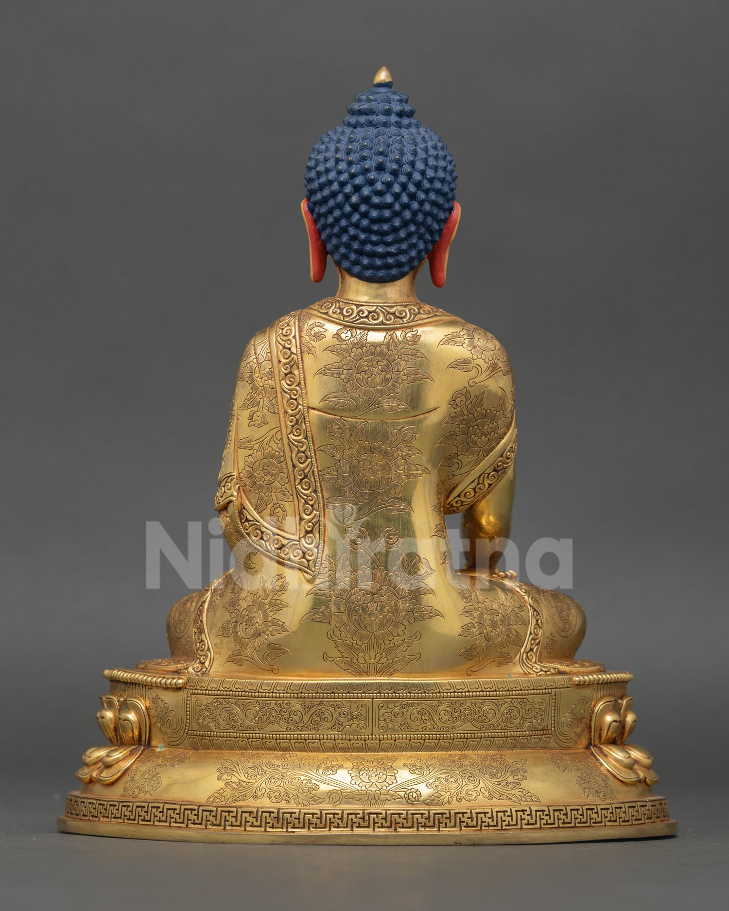 Back view of Shakyamuni Buddha statue double lotus base intricate robe carving Nepal handmade sacred sculpture spiritual home altar decoration