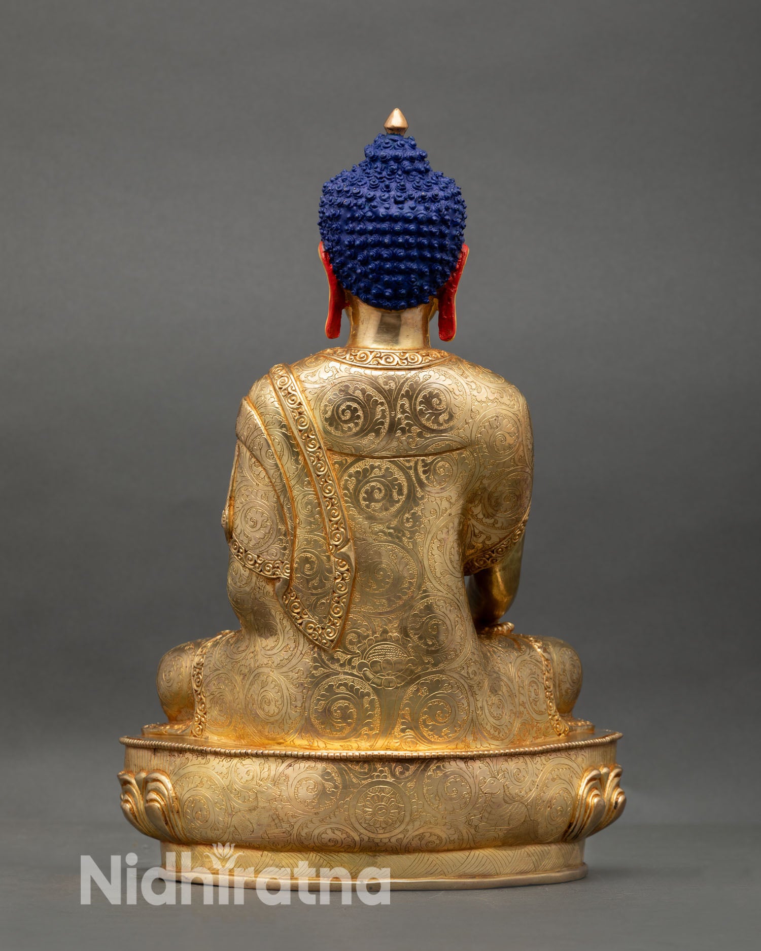 Back view of Shakyamuni Buddha statue showing detailed robes and gold finish Nepal handmade Buddhist sculpture for home shrine decor and spiritual interior