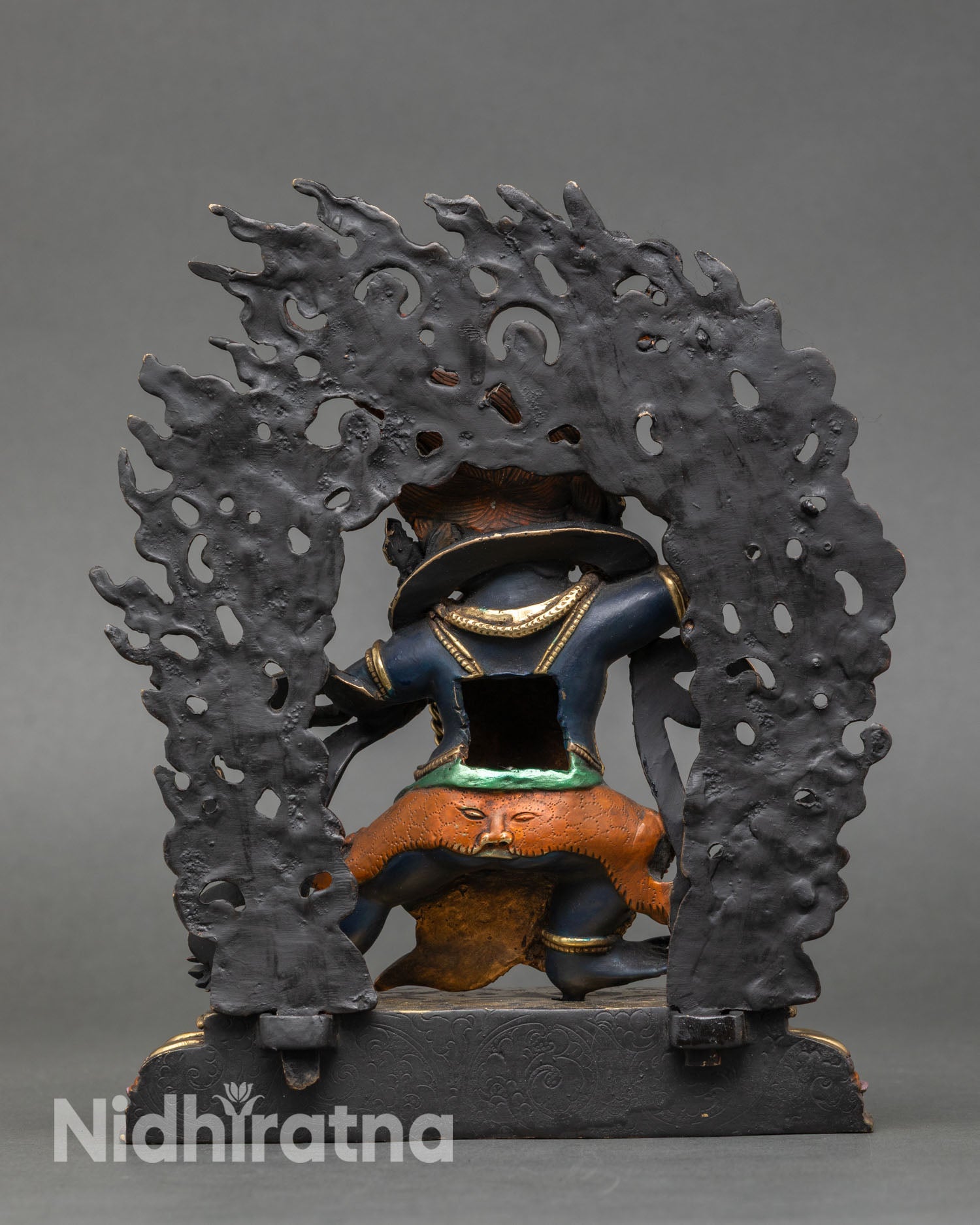 Back view of Vajrapani statue flame halo intricate details gold accents copper Himalayan art