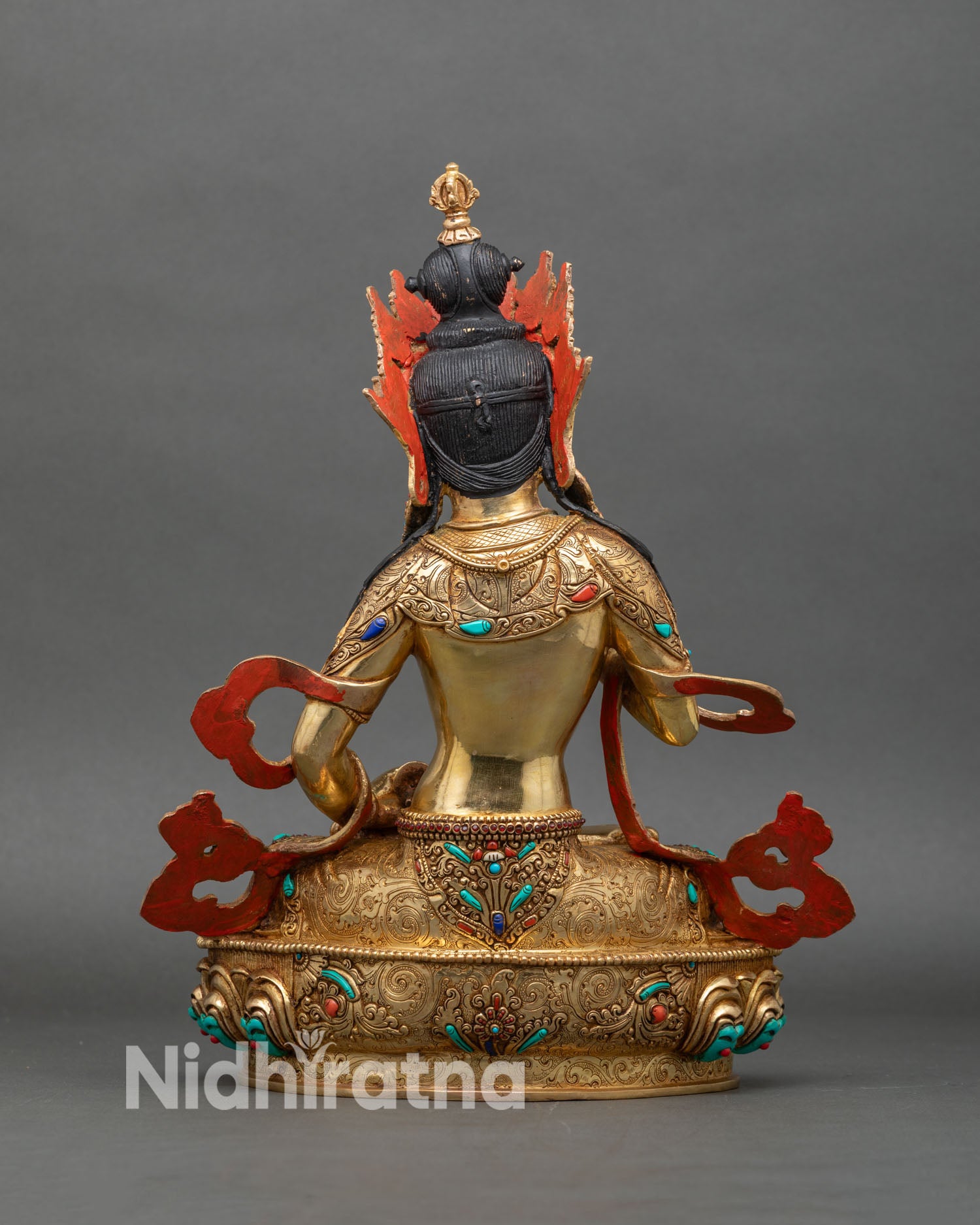 Back view of Vajrasattva statue showing detailed robes and lotus throne