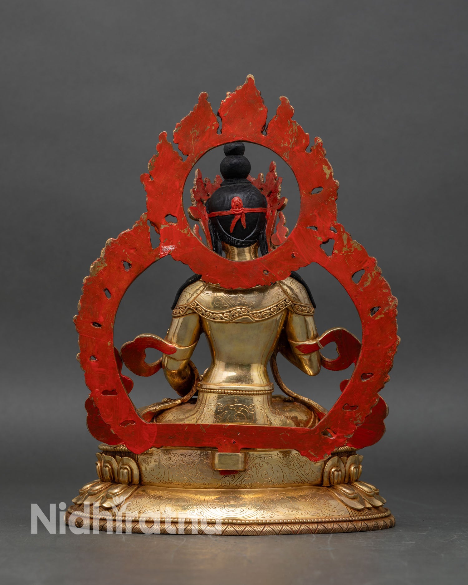 Back view of Vajrasattva statue, ornate lotus seat and radiant flaming aureole